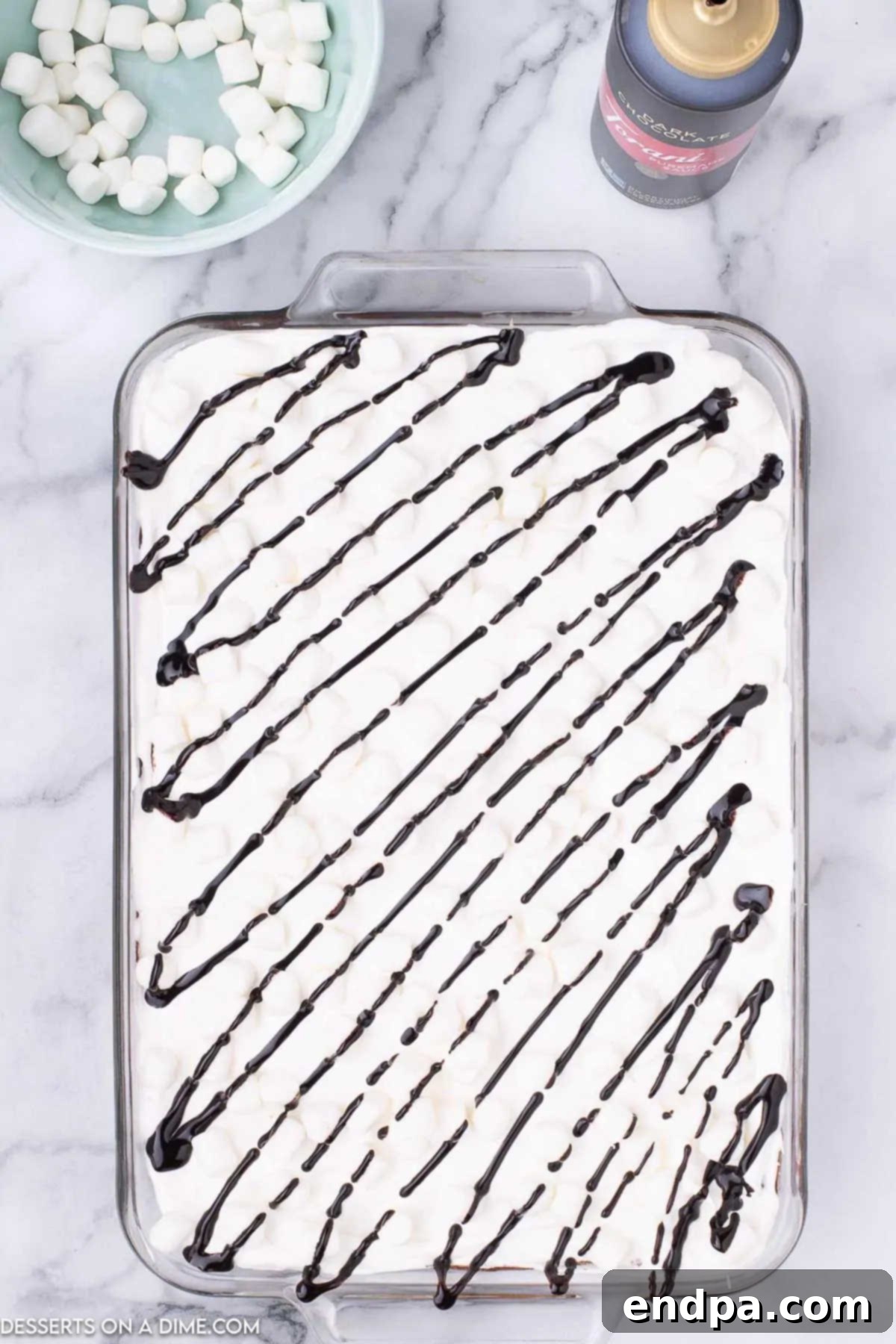 Decadent Hot Cocoa Lasagna 10 The Hot Chocolate Lasagna topped with mini marshmallows and a drizzle of chocolate syrup, ready for serving.