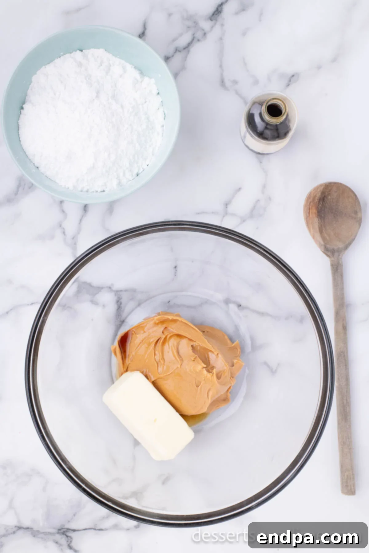 Decadent Chocolate Peanut Butter Bites 3 Creamy peanut butter and softened butter combined in a large mixing bowl, ready for mixing.