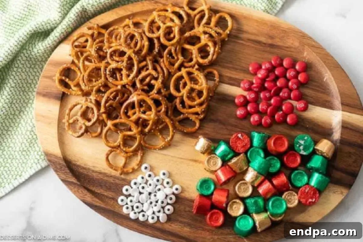Key Ingredients for Festive Reindeer Pretzels Ingredients laid out on a surface: mini pretzel twists, Rolo candies, red M&Ms, and small candy eyes.