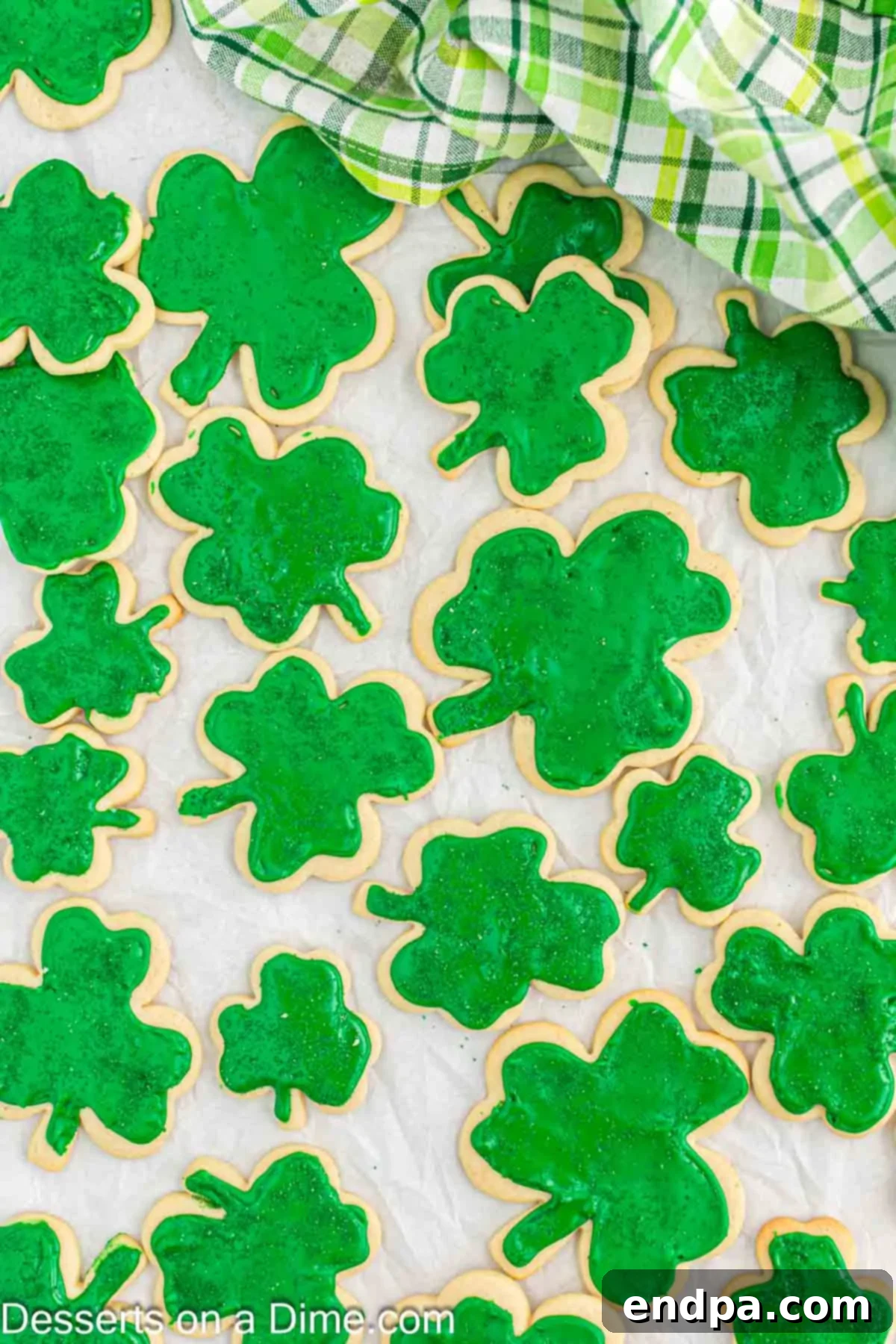 Emerald Clover Delights 15 A festive display of fully decorated shamrock cookies spread out on a counter, ready to be served and enjoyed for St. Patrick's Day.