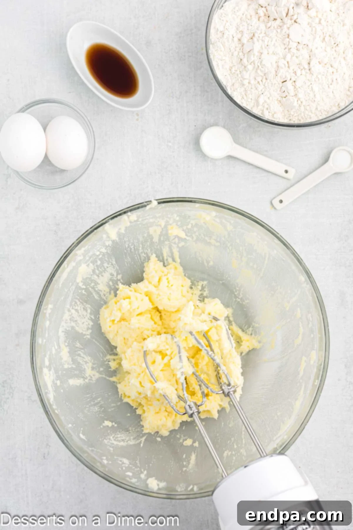 Emerald Clover Delights 4 Softened butter and granulated sugar being creamed together in a large mixing bowl with a paddle attachment until light and fluffy.