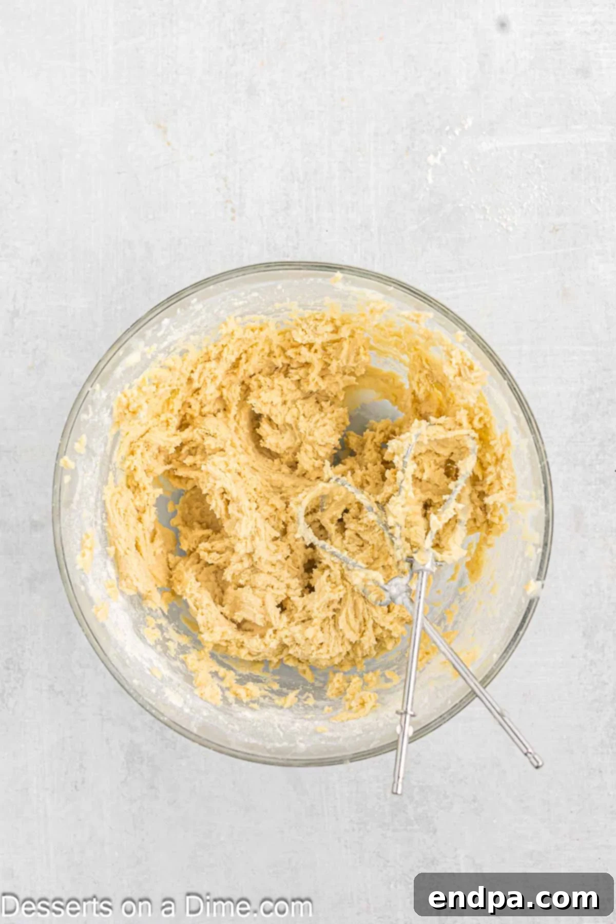 Emerald Clover Delights 6 Dry ingredients (flour, baking powder, and salt) being added to the wet mixture in a large mixing bowl, ensuring thorough blending.