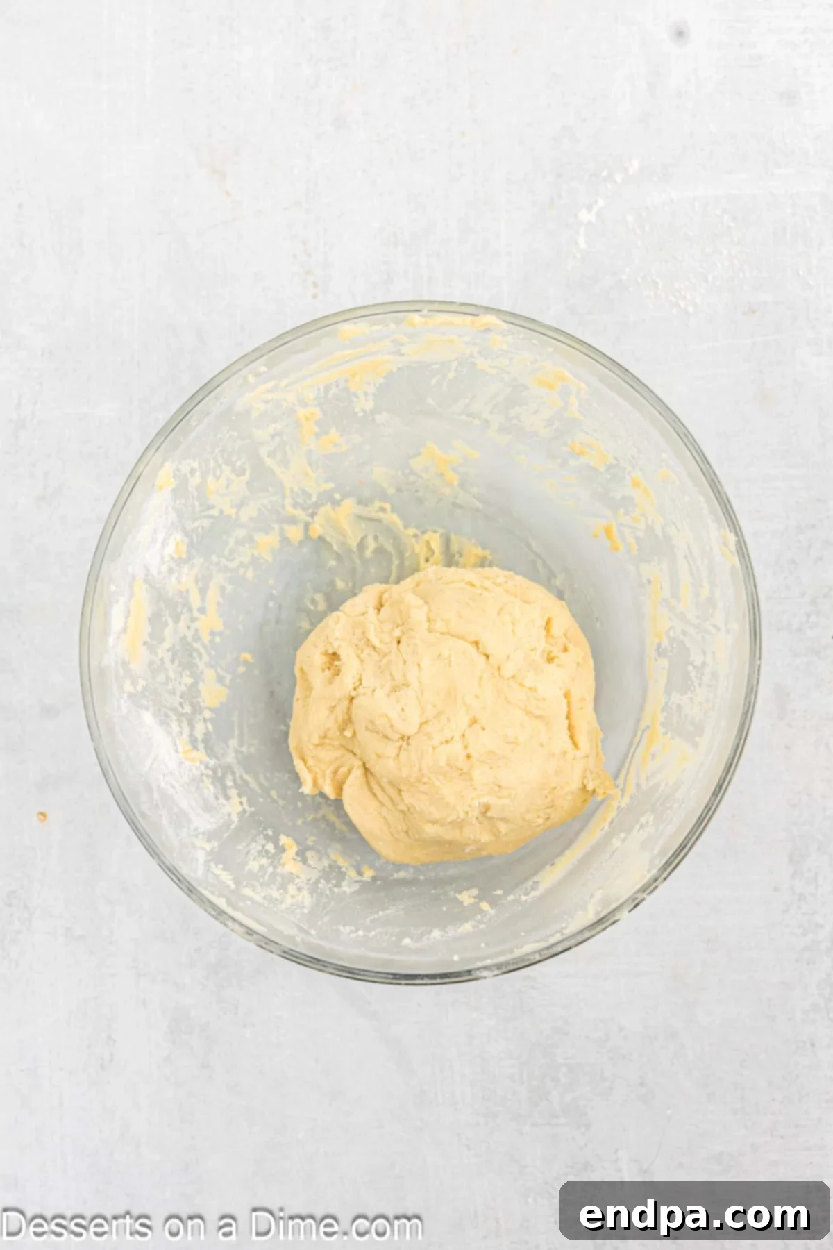 Emerald Clover Delights 7 Cookie dough formed into a ball and wrapped in plastic wrap, chilling in the refrigerator for several hours or overnight.