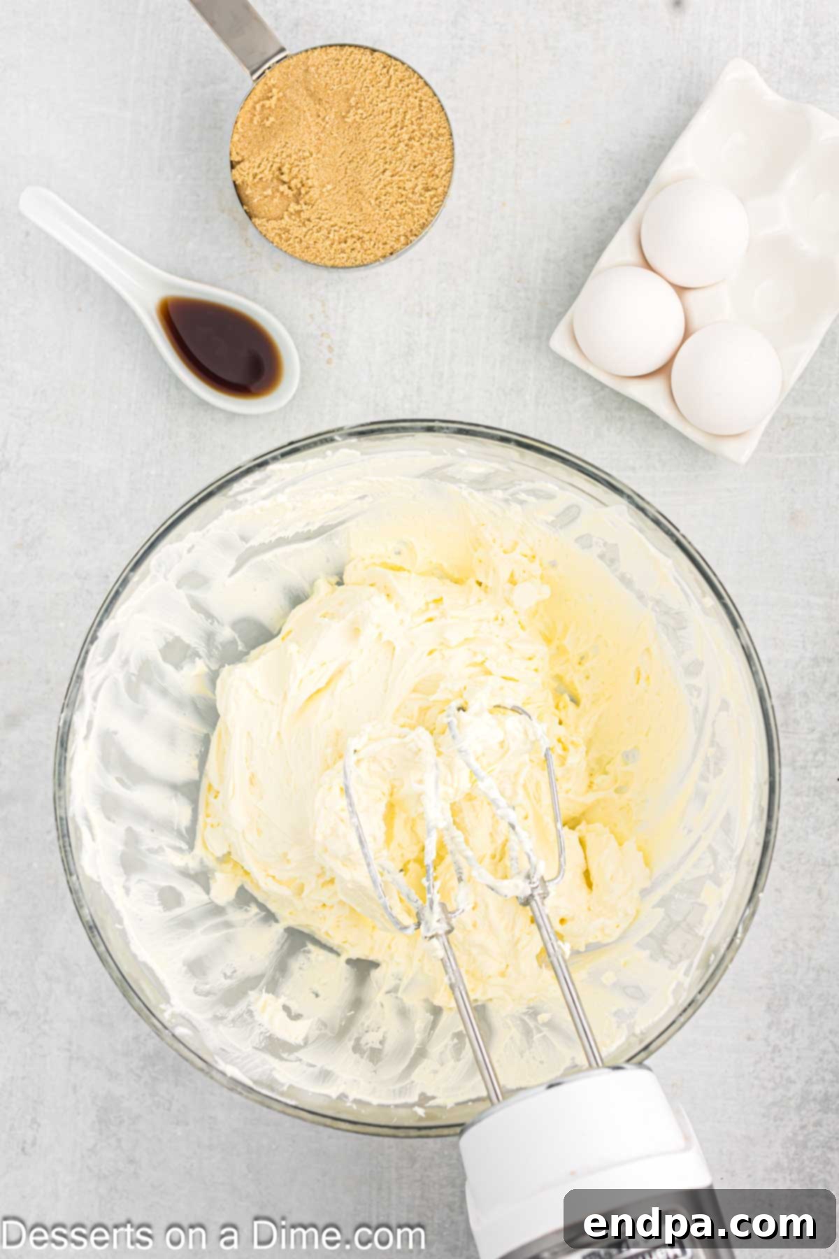 Softened cream cheese in a mixing bowl, ready to be beaten for the cheesecake filling.