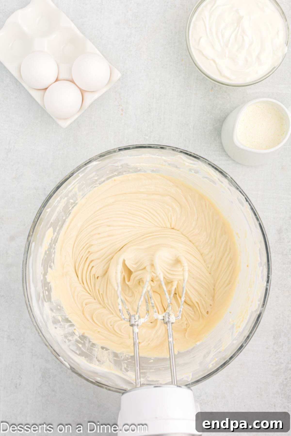 Light brown sugar and vanilla extract being added to the creamed cream cheese mixture.