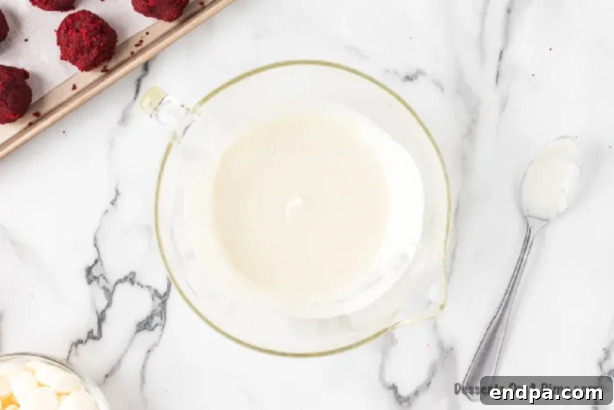 White chocolate chips and coconut oil melting together in a microwave-safe bowl.