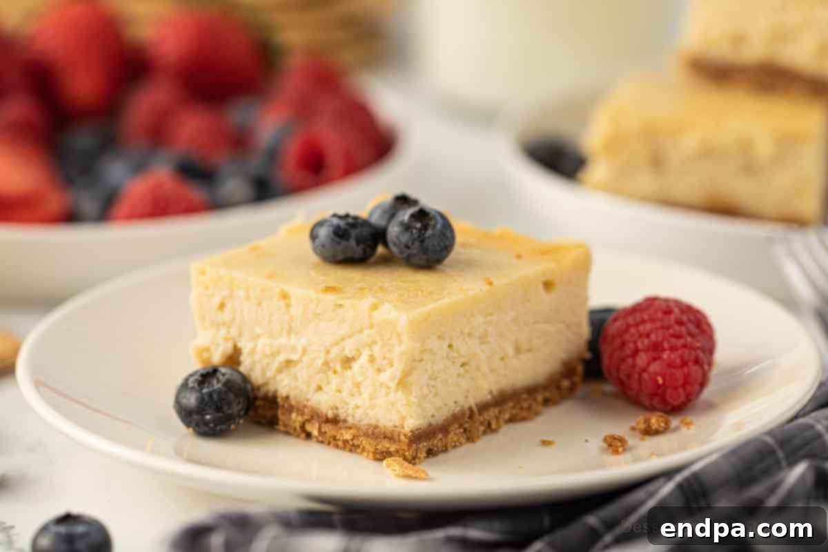 Creamy Cheesecake Delights 2 Delicious cheesecake bar cut into perfect squares on a white plate, ready to be served.