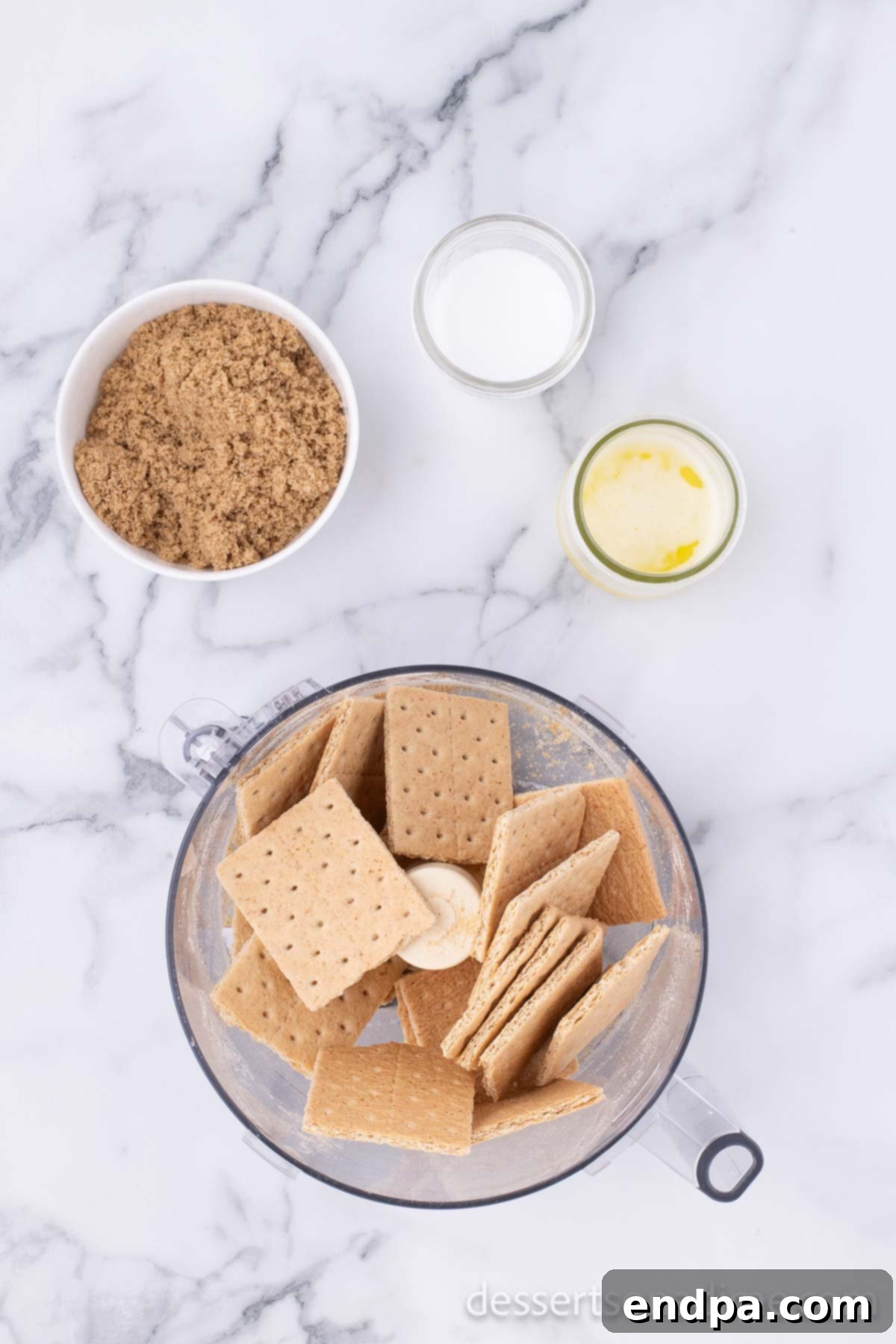 Creamy Cheesecake Delights 4 Graham crackers being crushed in a food processor to make fine crumbs for the crust.