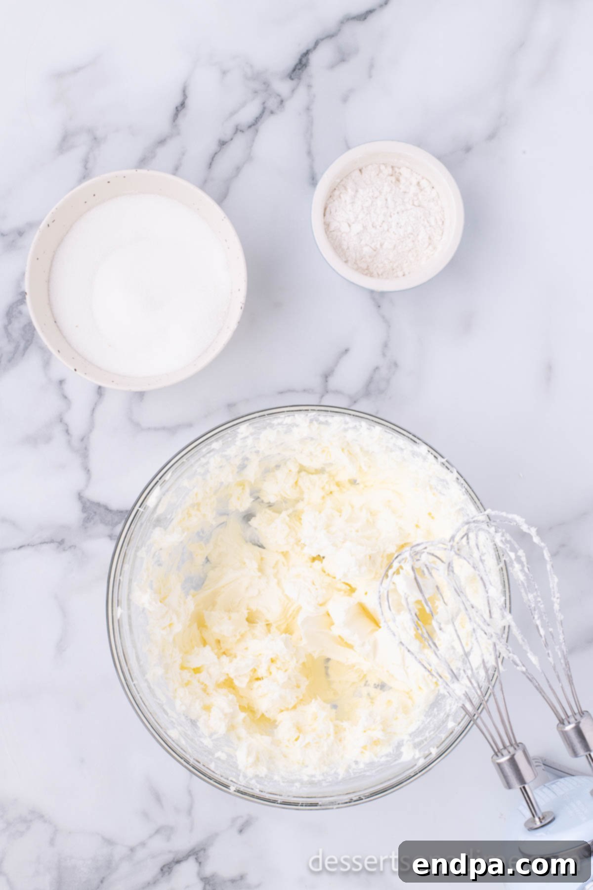 Creamy Cheesecake Delights 6 Cream cheese and sugar beaten together in a bowl until light and fluffy with an electric mixer.