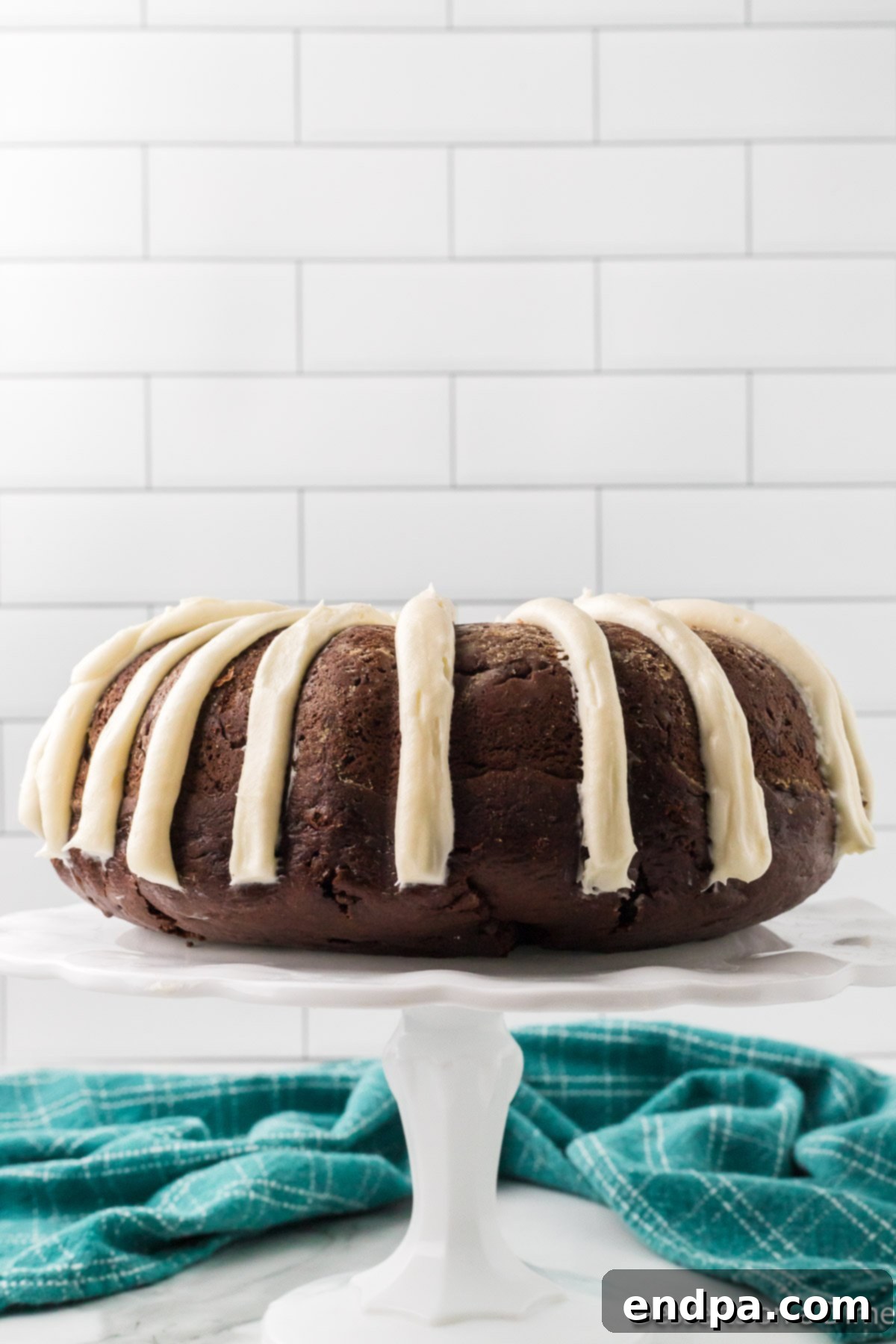 Bundt Cake on pedestal with frosting. 