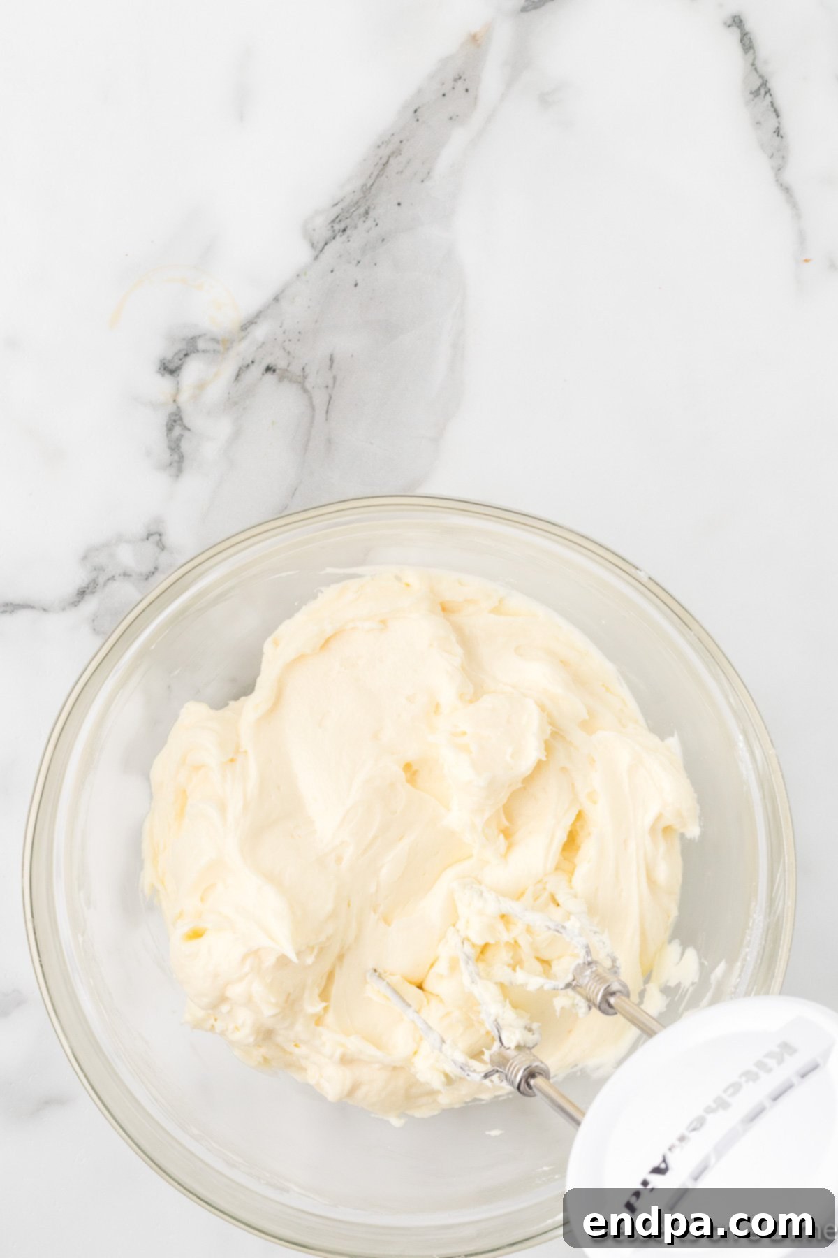 Cream cheese and butter combinedin mixing bowl for frosting. 