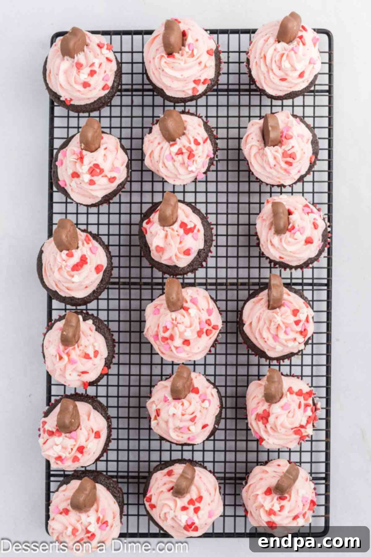 Sweetheart Swirl Cupcakes 8 Cupcakes topped with frosting on wire rack.