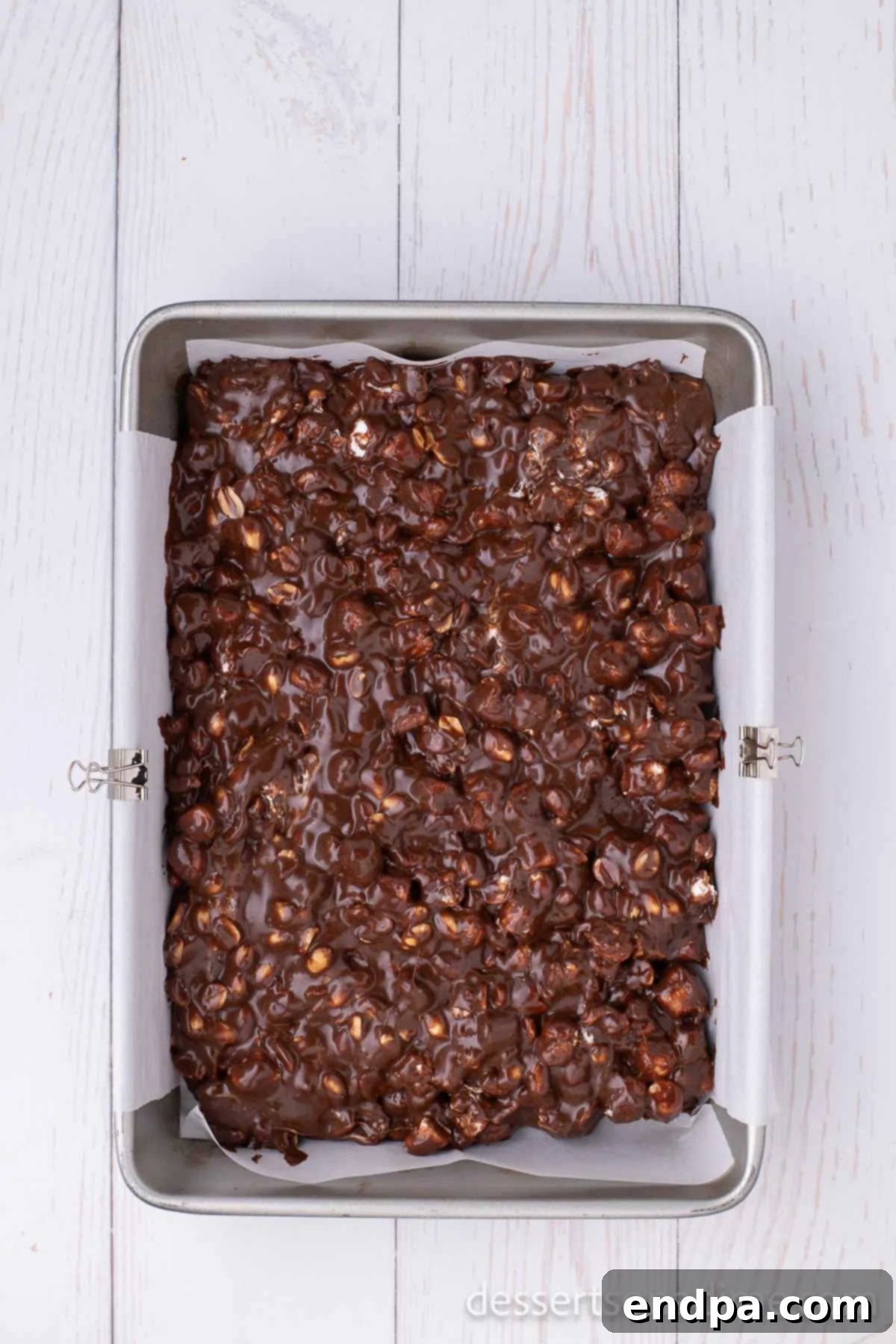 Decadent Rocky Road Dream 6 Rocky Road mixture spread evenly into the parchment-lined baking pan, ready for chilling.