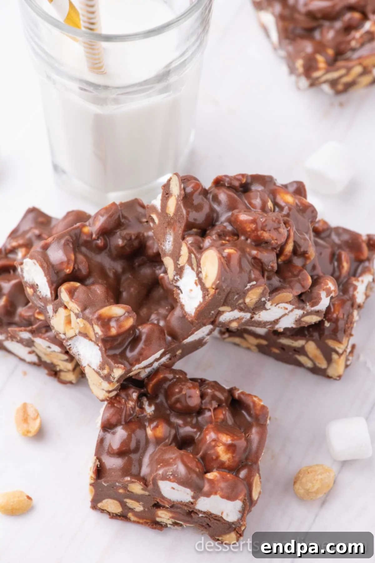 Decadent Rocky Road Dream 8 Close-up of freshly cut Rocky Road Candy squares, piled high, showing the detailed texture of chocolate, marshmallows, and peanuts.