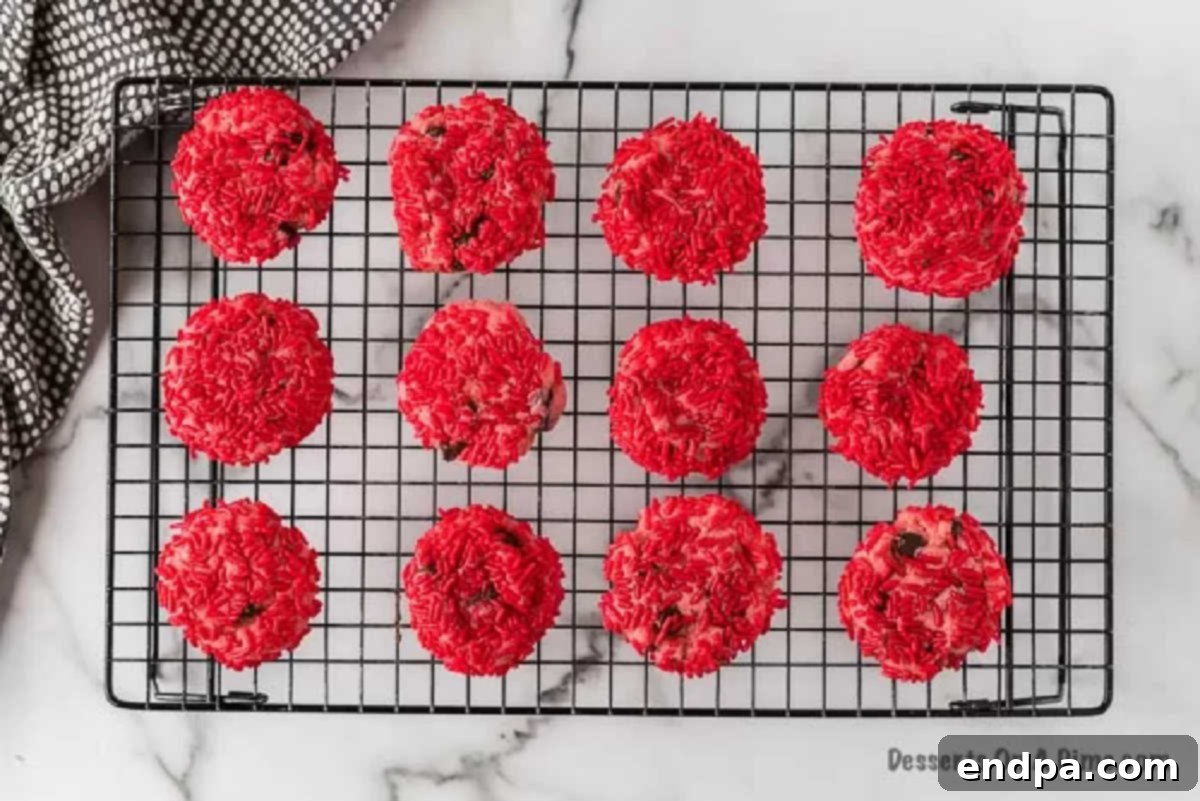 Baked cookies arranged on a wire rack, allowing air circulation for thorough cooling.