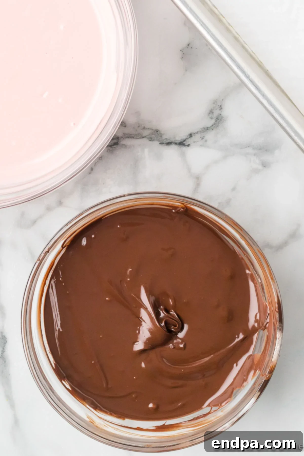 Bowl of melted chocolate, smooth and ready to spread.