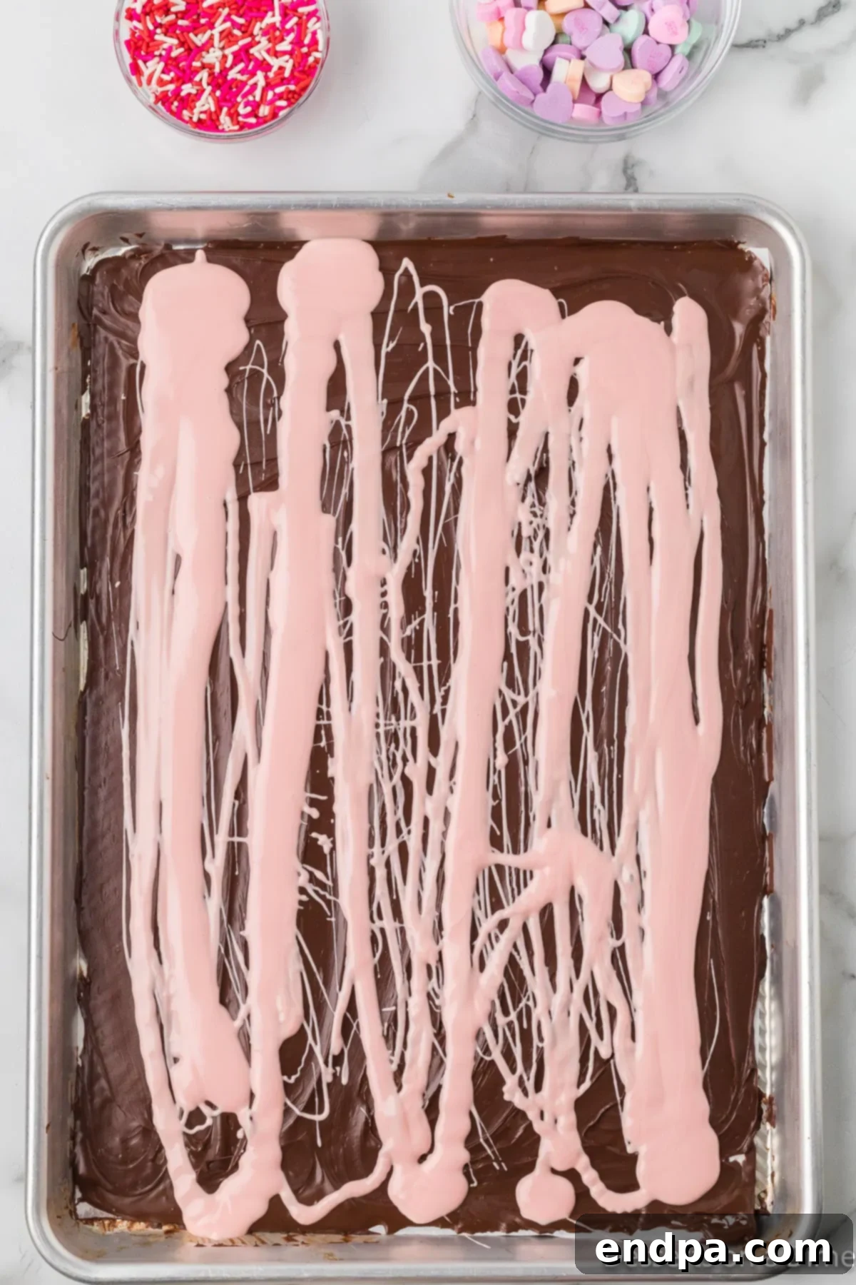 Pink candy melts drizzled in lines over the dark chocolate base.
