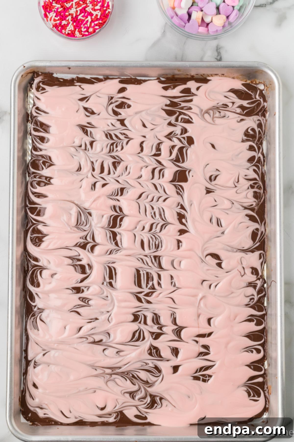 Pink candy melts swirled into the chocolate with a fork to create a marble effect.