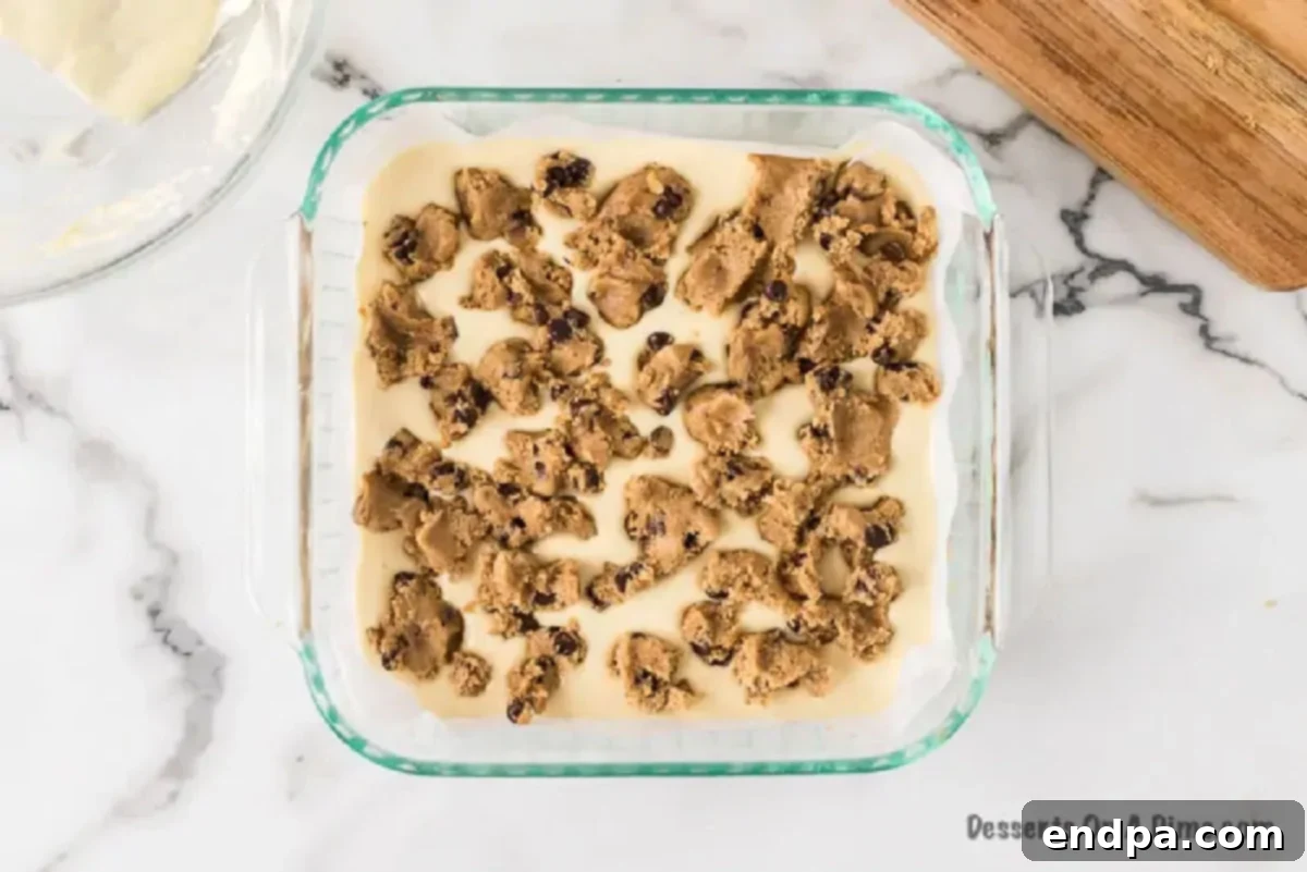 Remaining cookie dough crumbled over the top of the cheesecake filling.