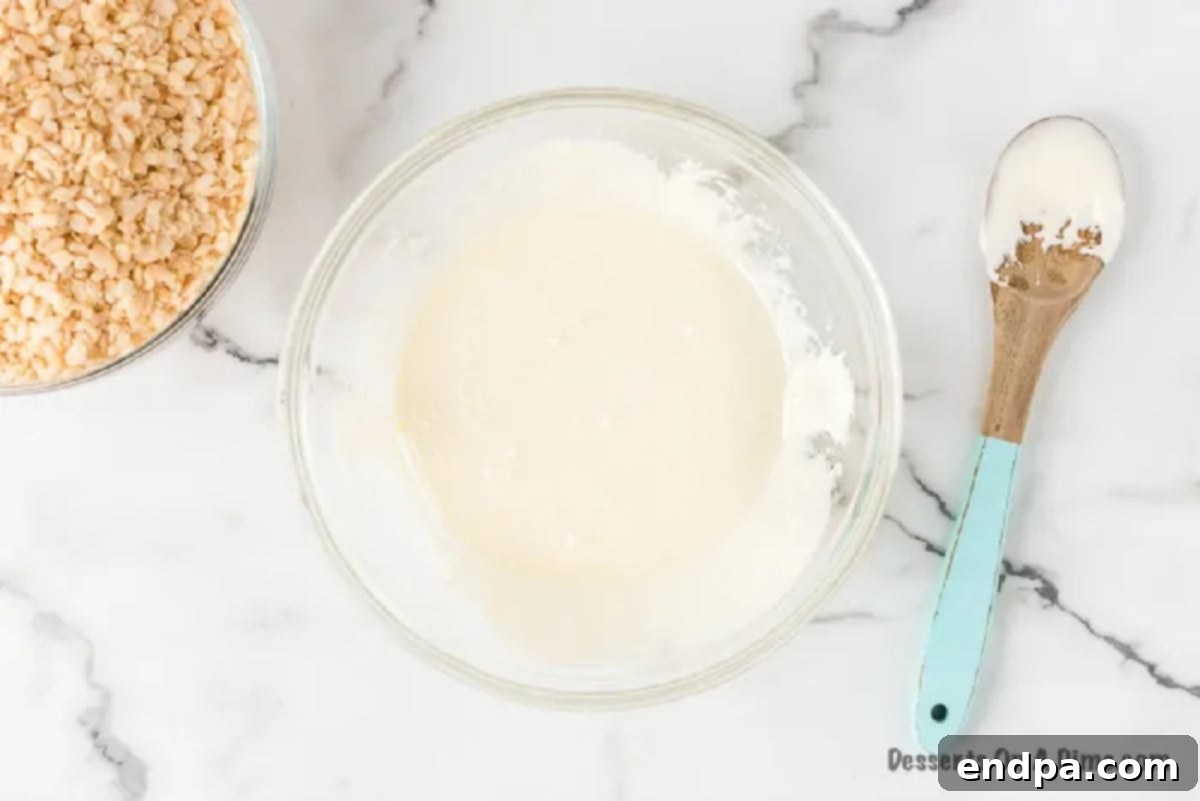 Melting butter and marshmallows in a mixing bowl for Rice Krispie Treats.