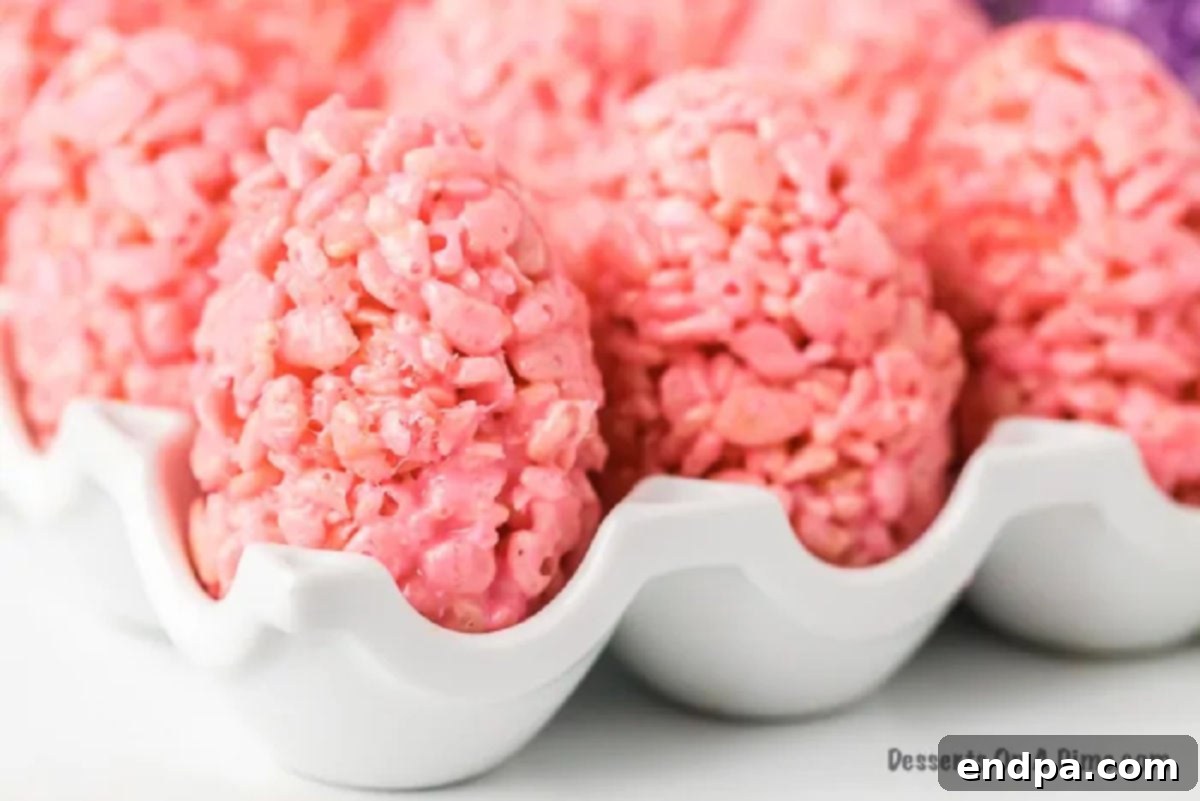 A close-up shot of several colorful, perfectly shaped Rice Krispie Easter Egg Treats.