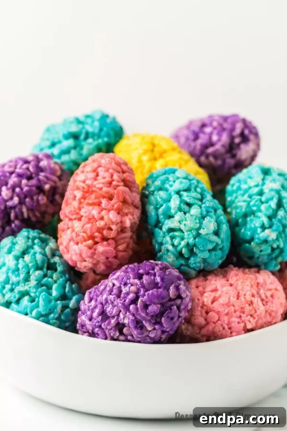 A bowl filled with colorful Easter Egg Rice Krispie Treats, ready for serving.