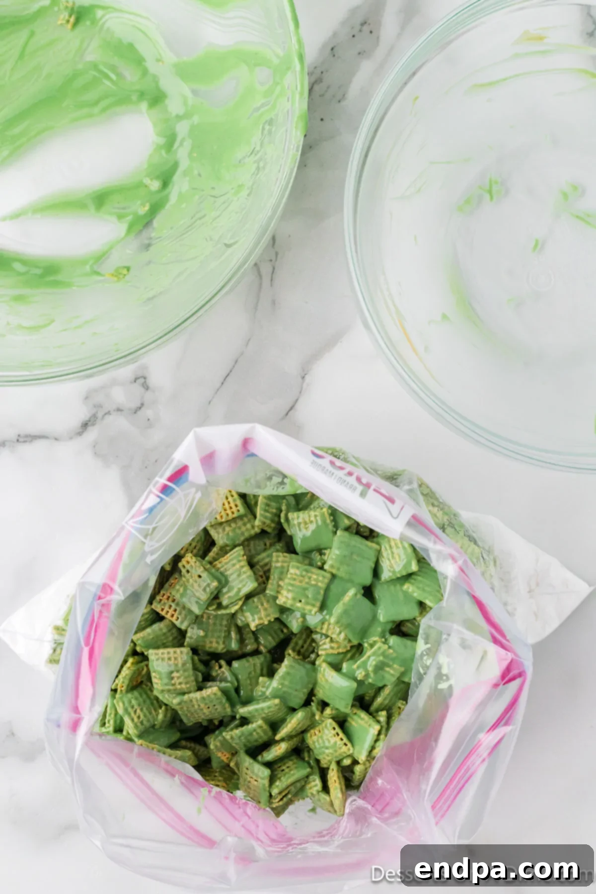 Whoville Christmas Crunch 7 Coated cereal inside a gallon-sized ziplock bag, ready for shaking with powdered sugar.