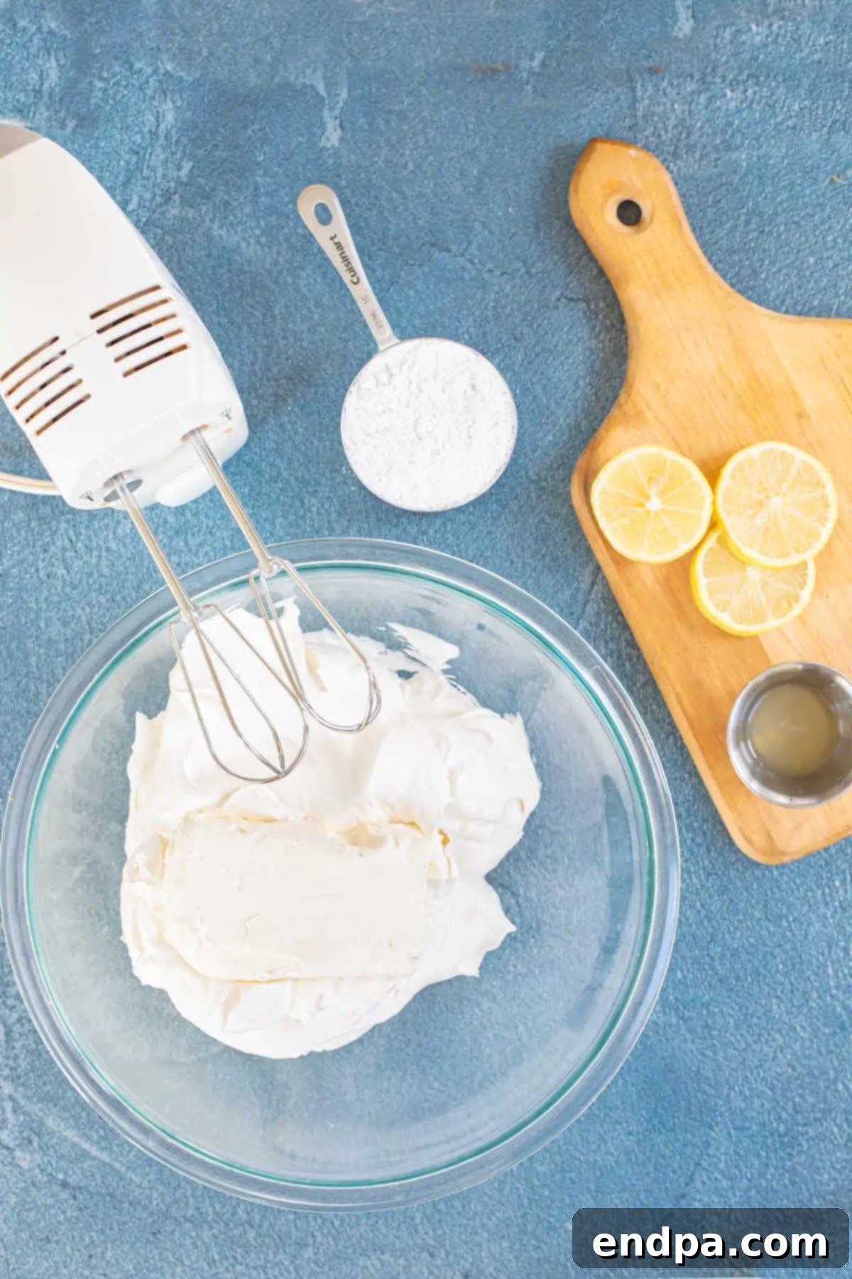 Cream cheese and cool whip mixed together in a bowl, showing a smooth, creamy texture.