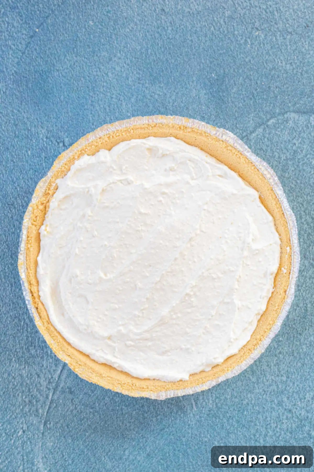 Cheesecake mixture smoothly spread into the pie crust, ready for chilling.