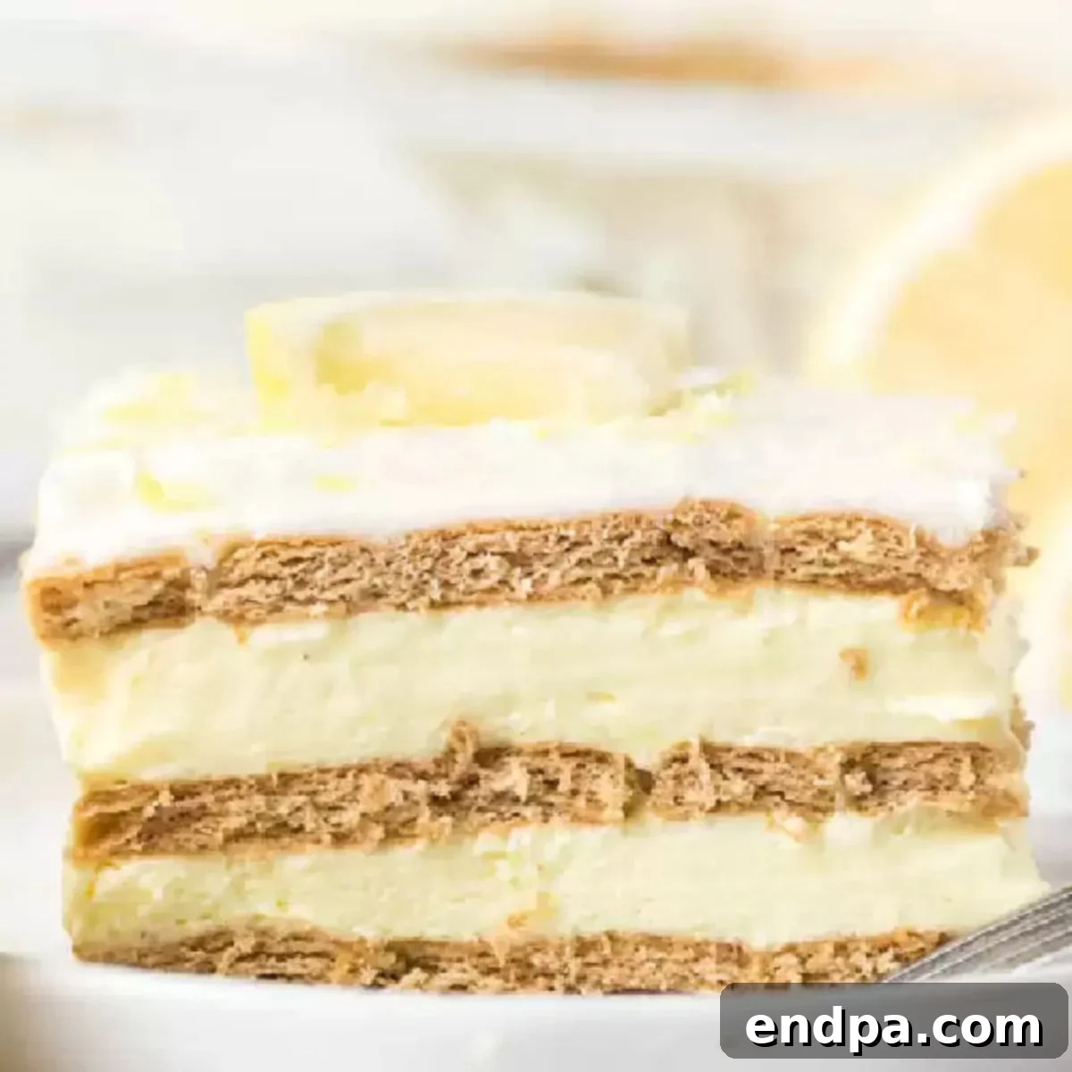A square image of a fully assembled Lemon Icebox Cake slice, showcasing its inviting layers.