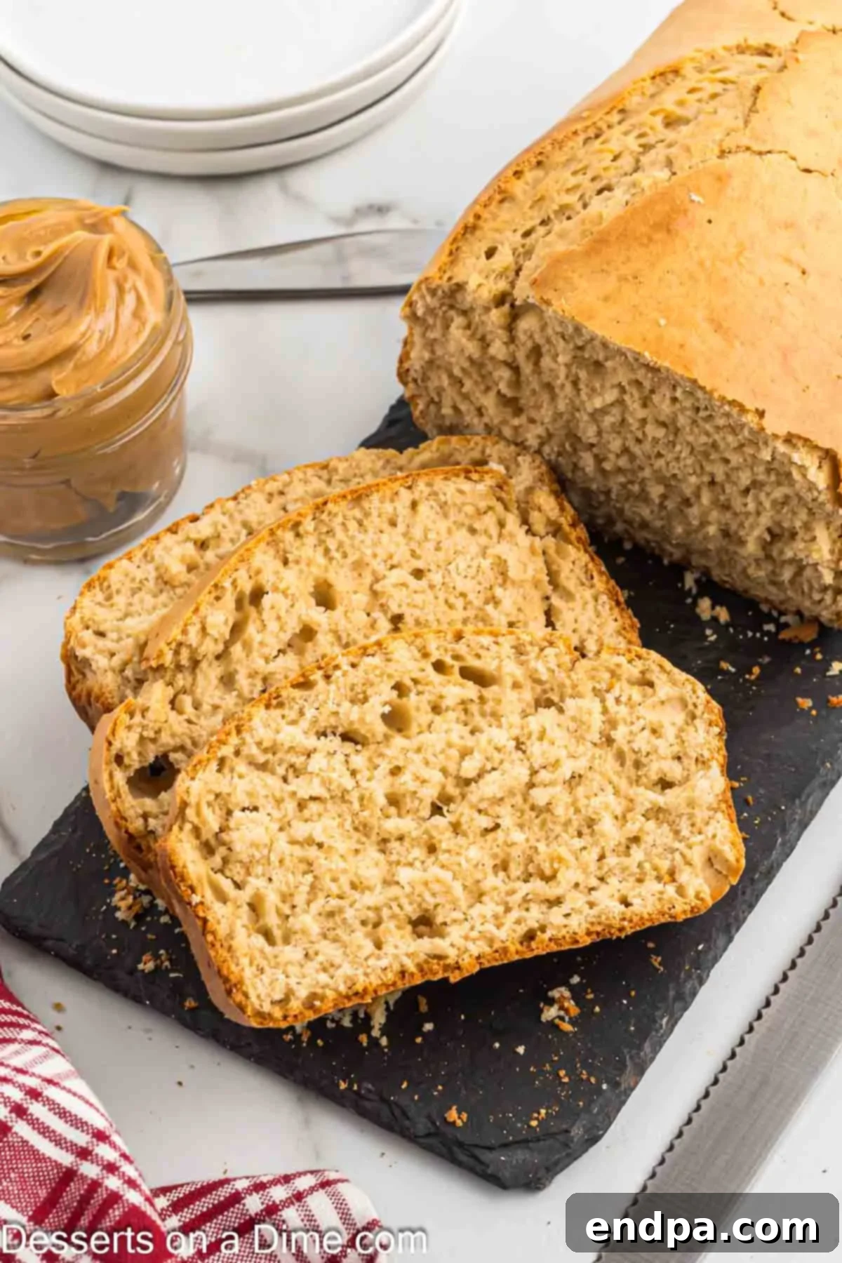 Several perfectly sliced pieces of peanut butter bread, showcasing its moist, fluffy texture and ready to be enjoyed as a snack or breakfast.