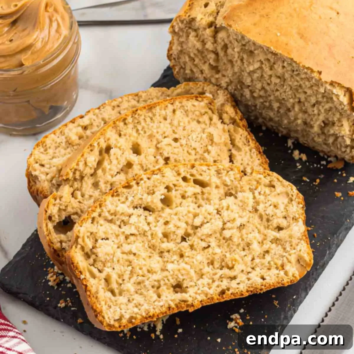A beautifully baked loaf of peanut butter bread, sliced and ready to serve, highlighting its inviting texture.