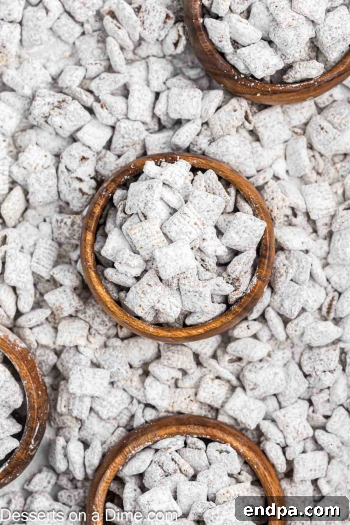 Delicious Puppy Chow in bowls, ready to be served as an easy no-bake dessert or snack.