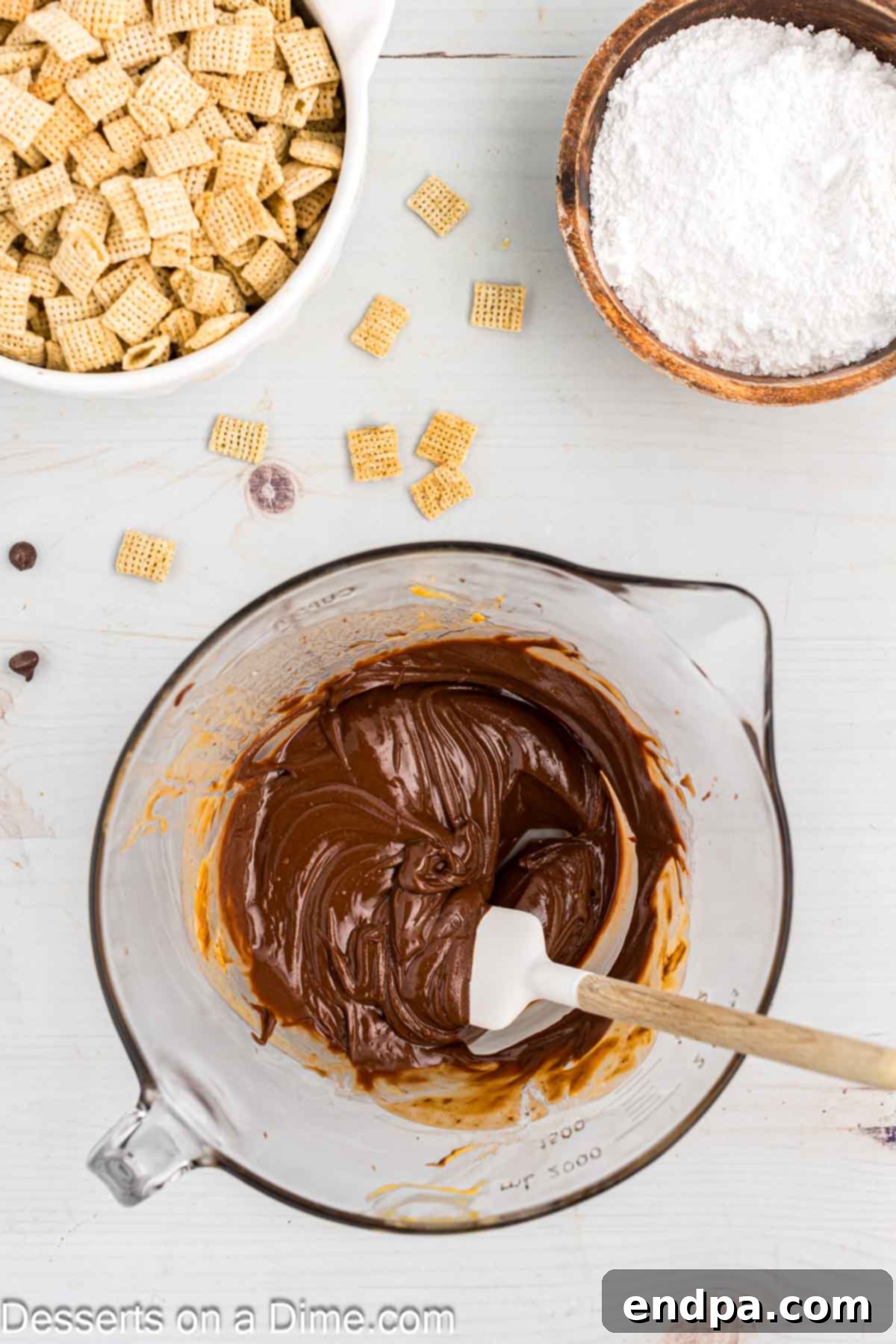 Melting chocolate, peanut butter, butter, and vanilla in a microwave-safe bowl for Puppy Chow.