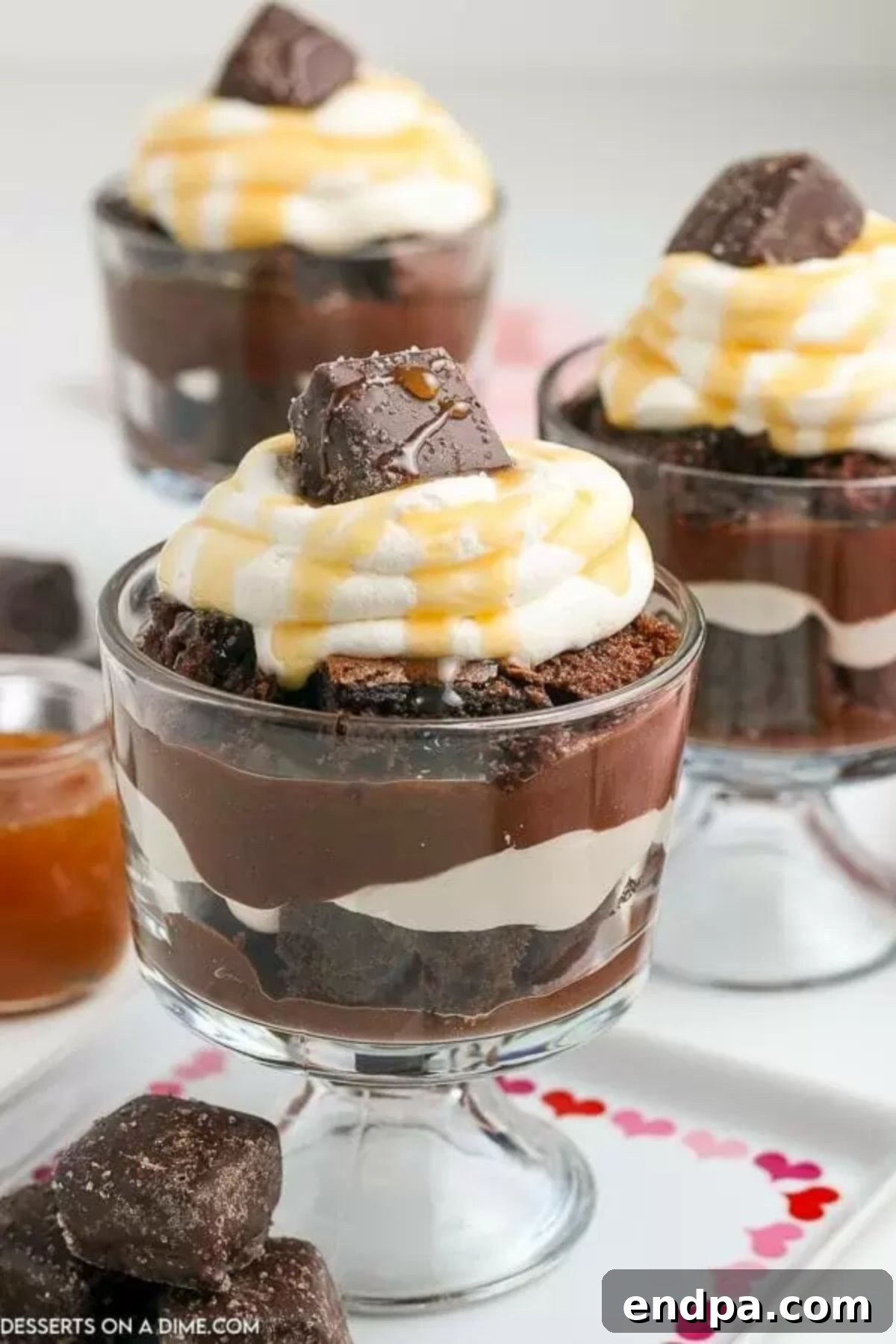 Decadent Layered Chocolate Trifle 2 Chocolate Trifle in a glass bowl topped with whipped cream and caramel syrup