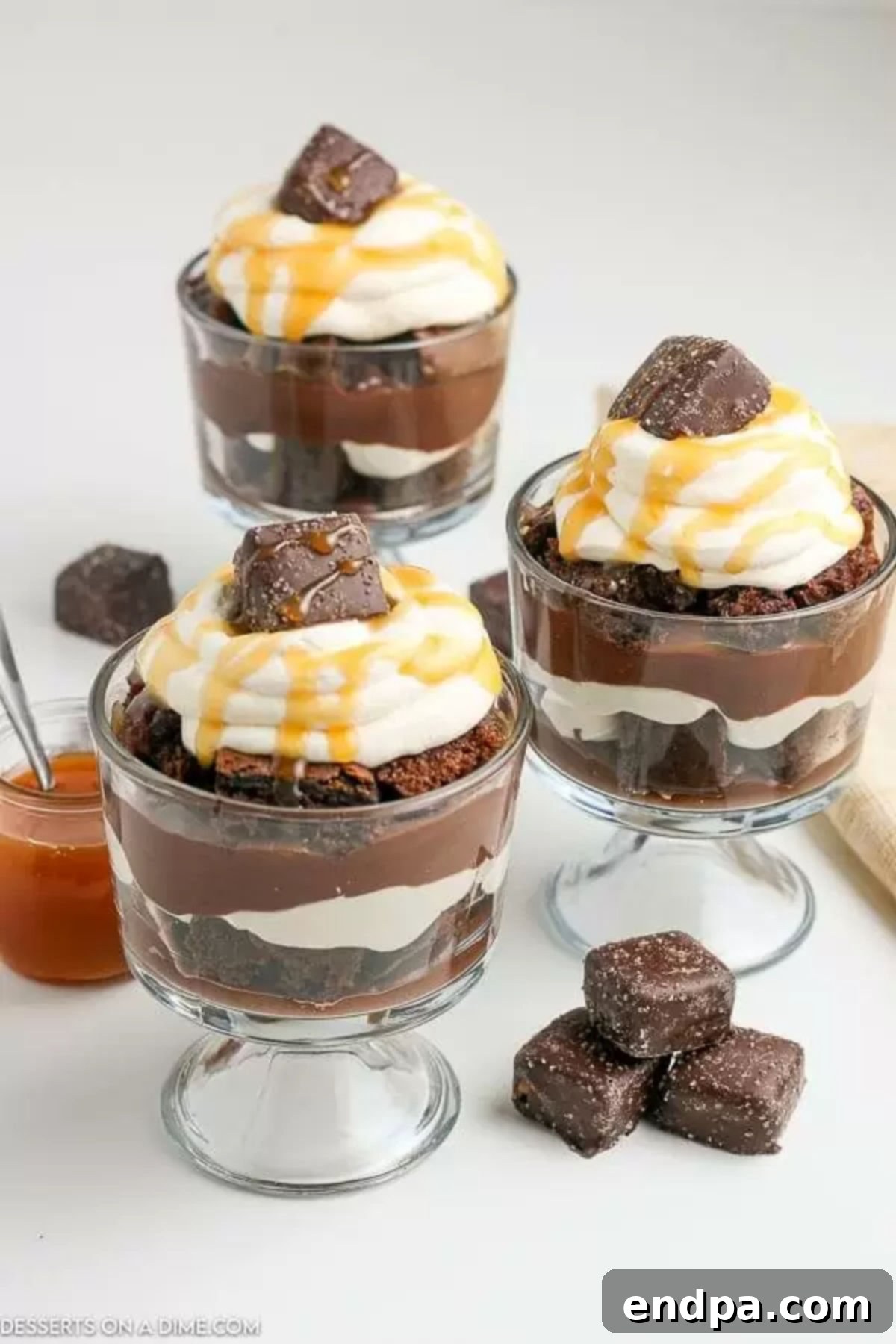 Decadent Layered Chocolate Trifle 4 Chocolate Trifle in a glass bowl topped with whipped cream and caramel syrup