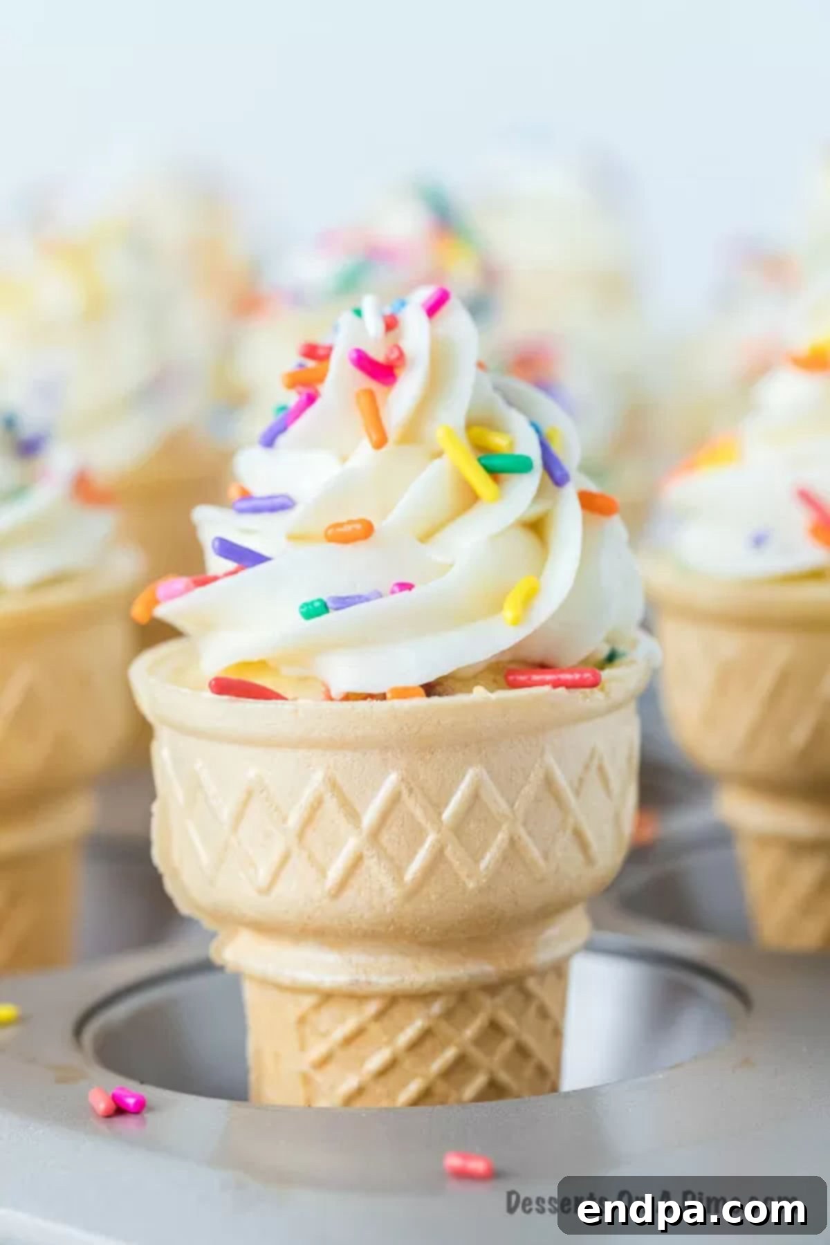 Sweet Cones of Cake 2 Ice Cream Cone Cupcakes arranged neatly in a muffin pan, ready for baking.
