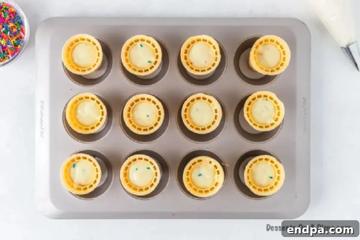 Sweet Cones of Cake 6 Batter carefully poured into flat-bottom cones resting in a muffin pan.