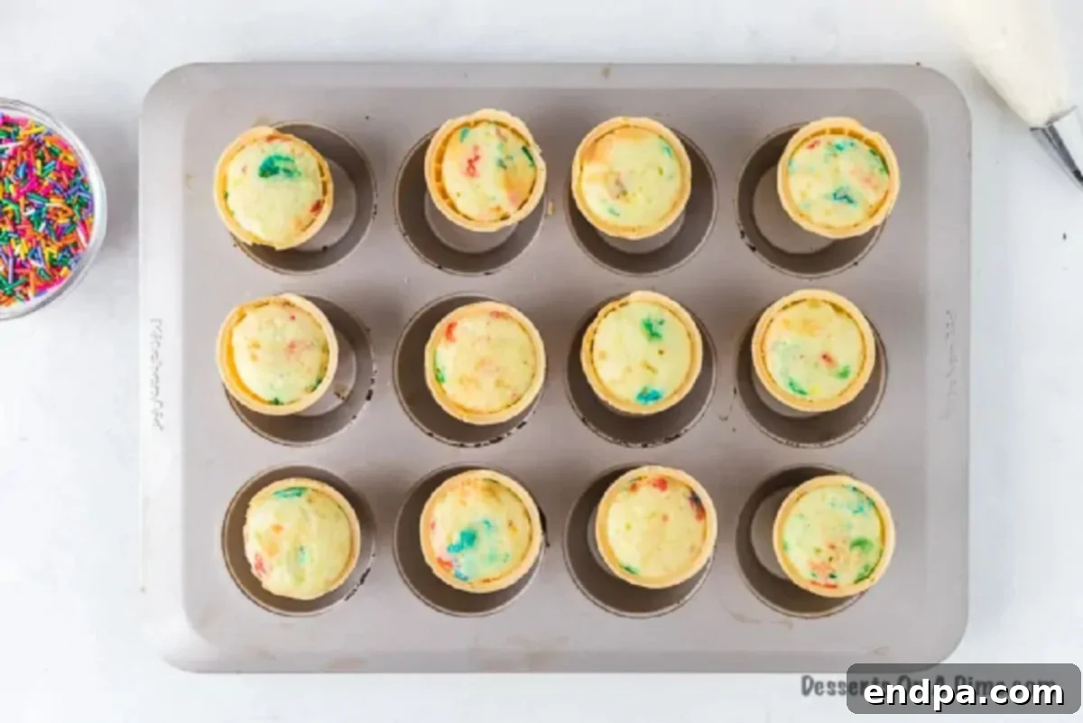 Sweet Cones of Cake 7 Baked ice cream cone cupcakes cooling on a wire rack.