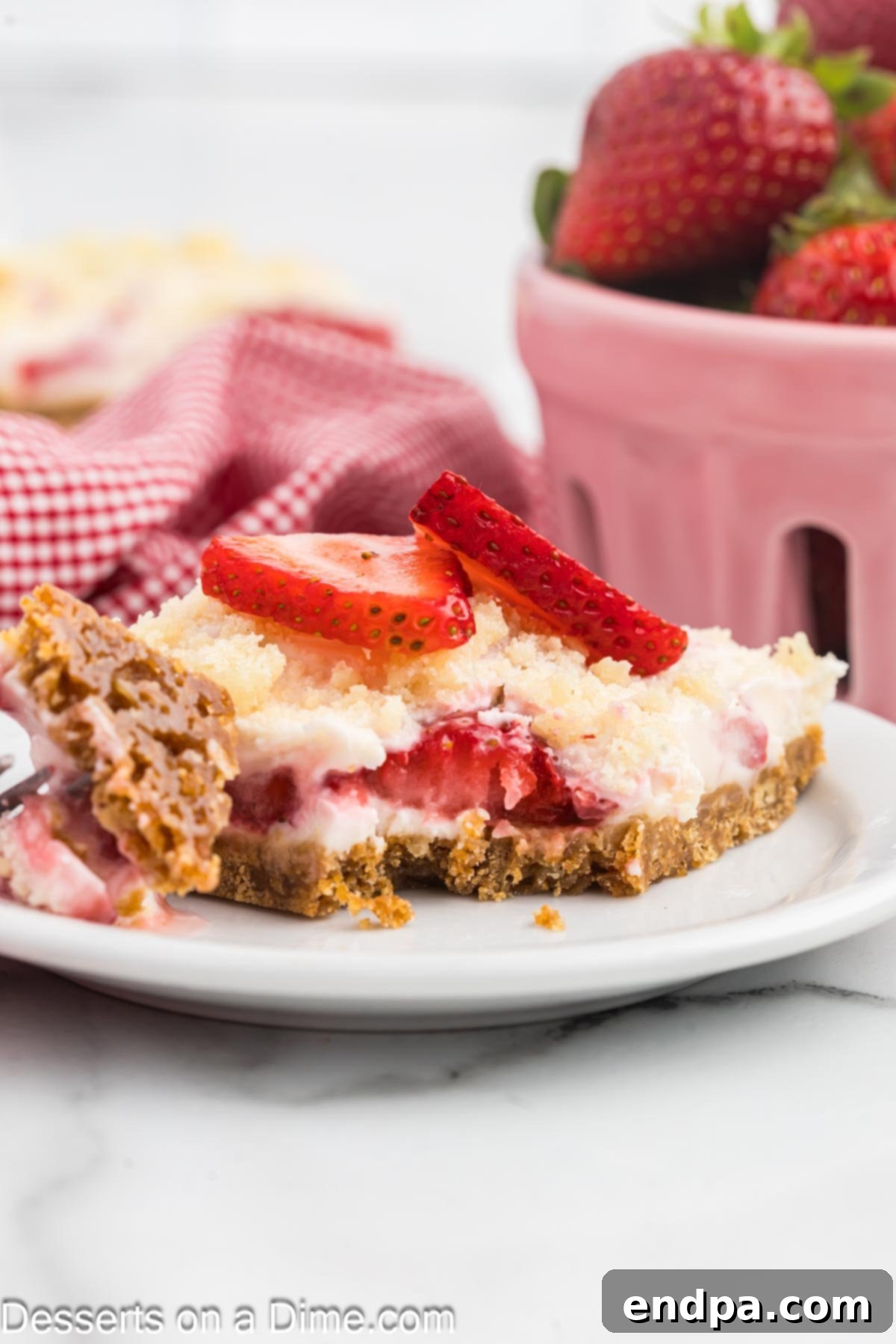 Strawberry Bars sliced and ready to serve on a plate.