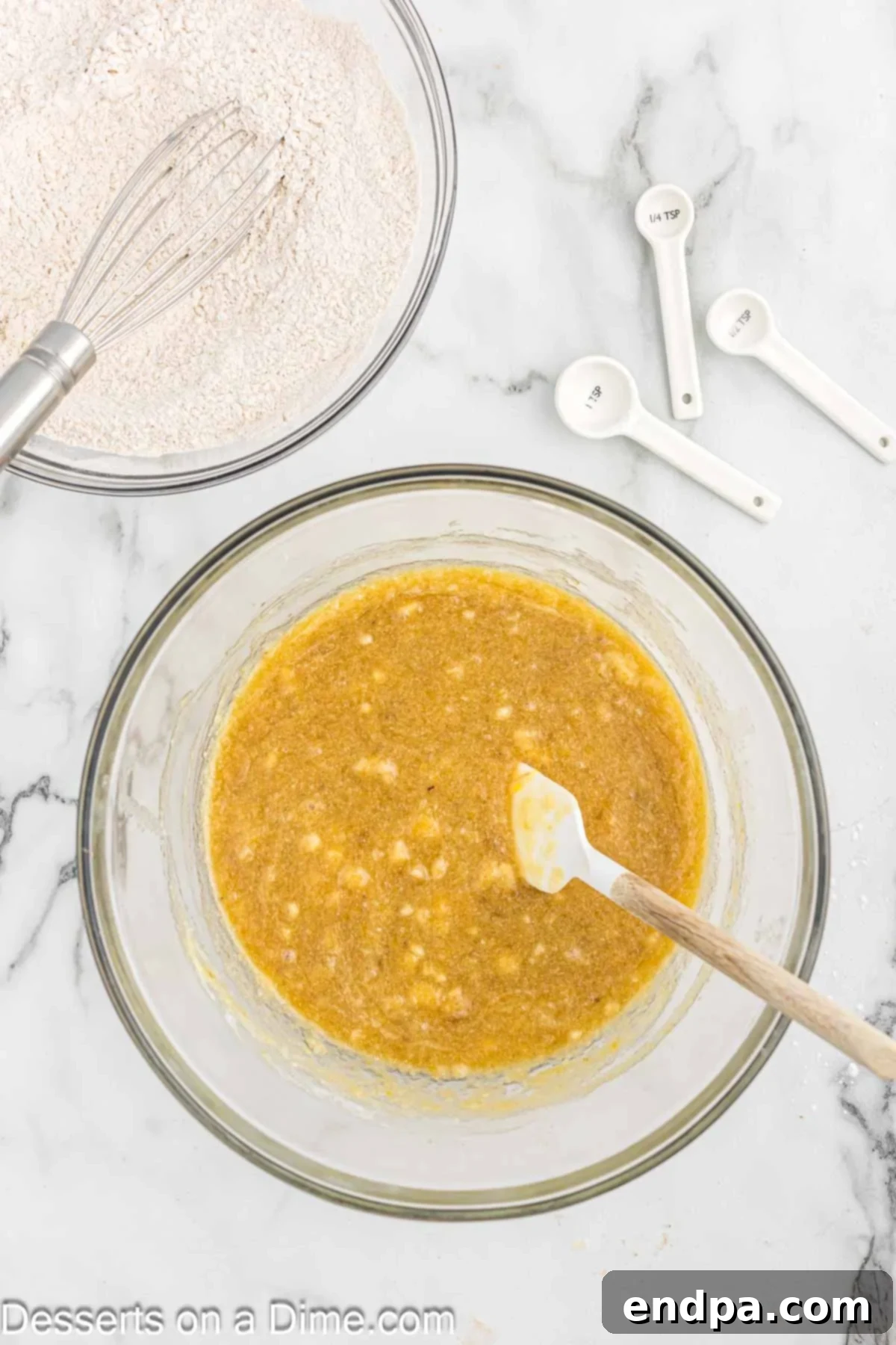 A separate bowl holds whisked dry ingredients for banana bread: flour, baking powder, baking soda, salt, and cinnamon.
