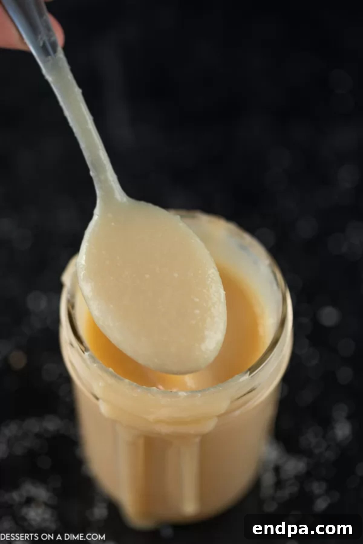 Sweetened Condensed Milk from Scratch 2 Homemade Sweetened Condensed Milk in a mason jar with a spoon