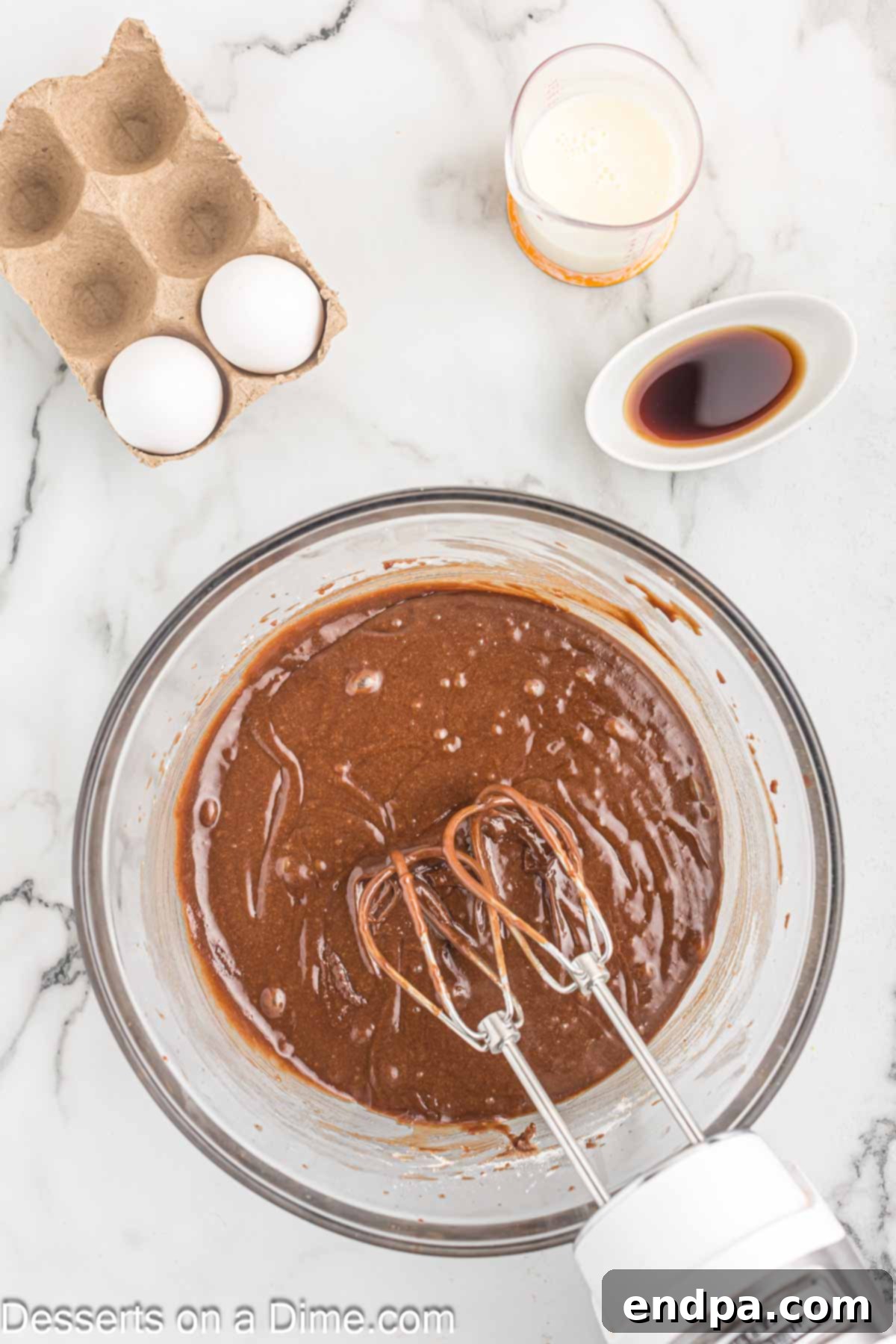 Effortless Decadent Chocolate Cake 5 Wet and dry ingredients for chocolate cake combined in a large mixing bowl, forming a smooth batter.
