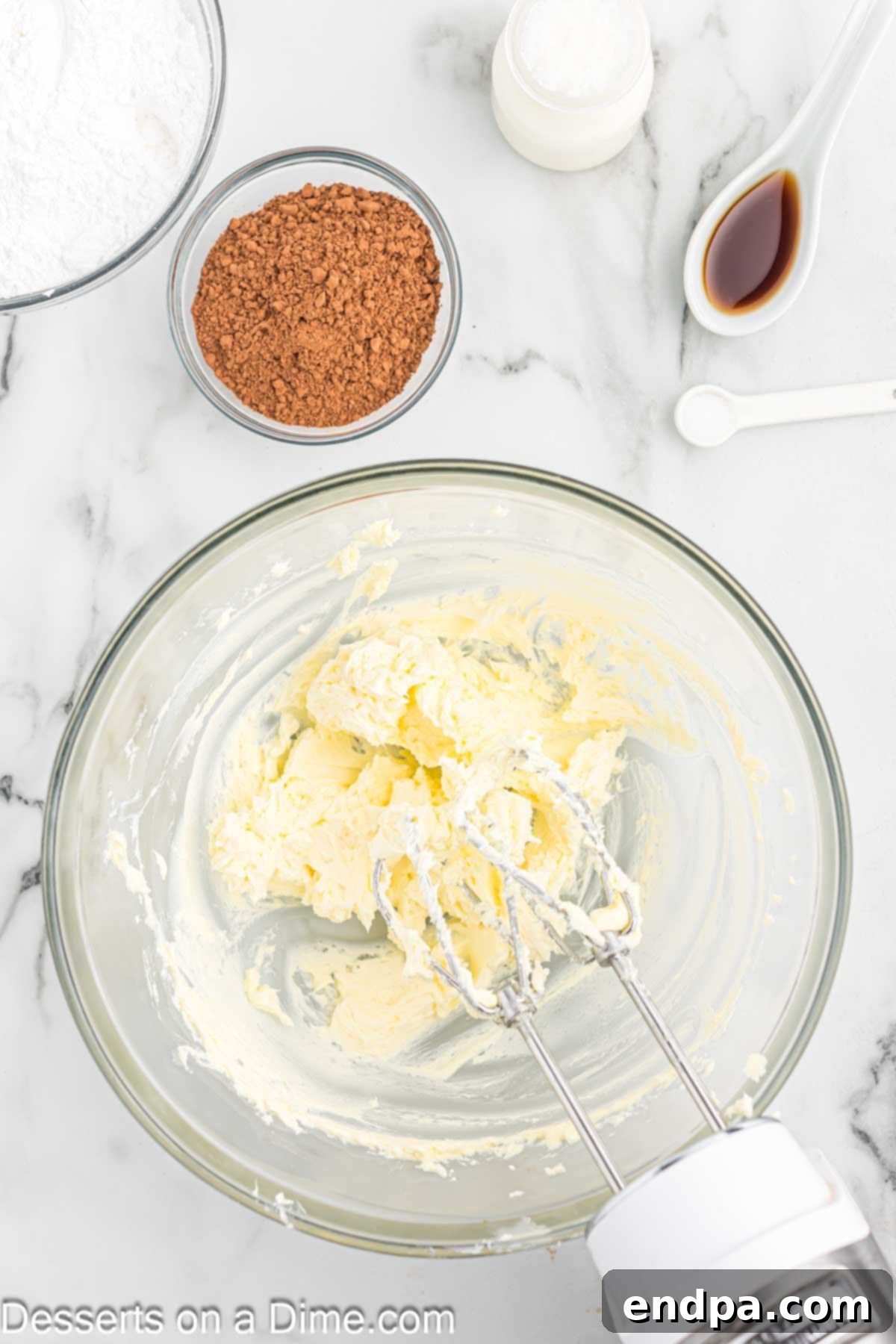 Effortless Decadent Chocolate Cake 7 Softened butter being creamed in a stand mixer, becoming light and fluffy, ready for the frosting.