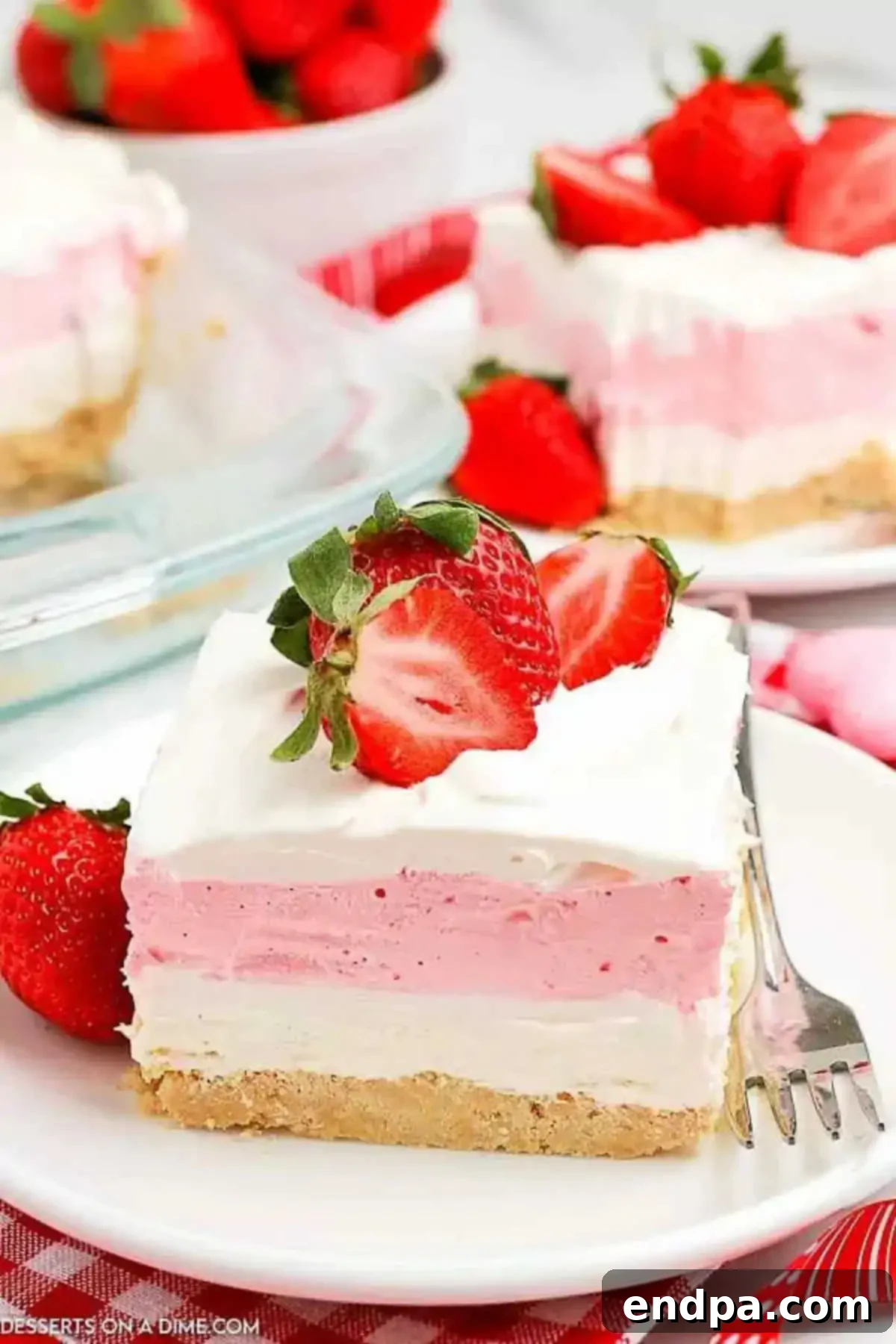 Strawberry Lasagna on a plate topped with fresh strawberries