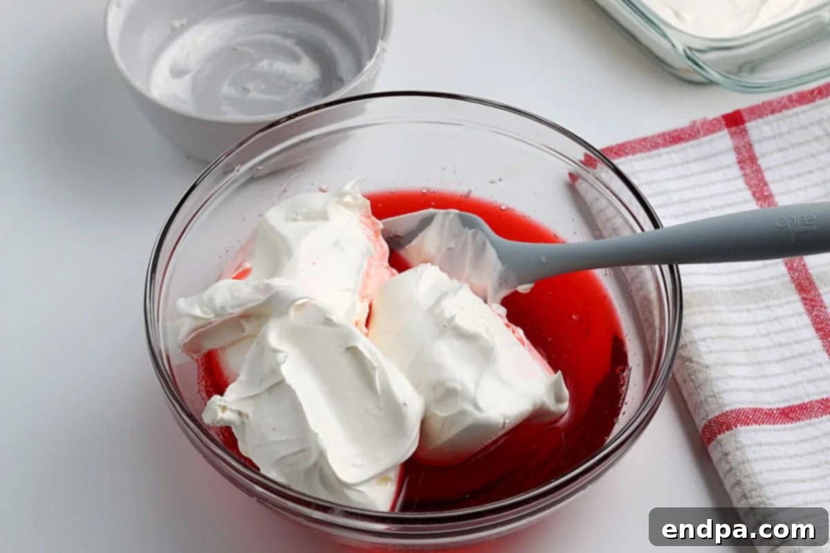 Whipped topping folded into gelatin mixture. 