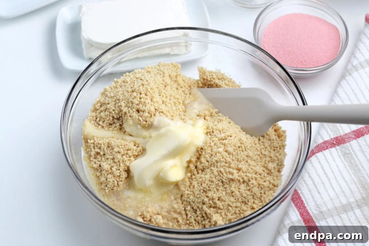 Cookie crumbs in bowl with melted butter. 