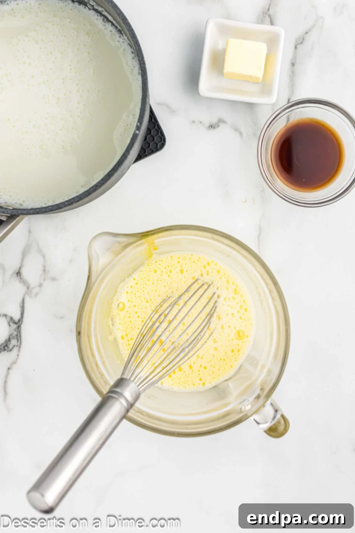 Egg yolks being lightly beaten in a separate bowl.