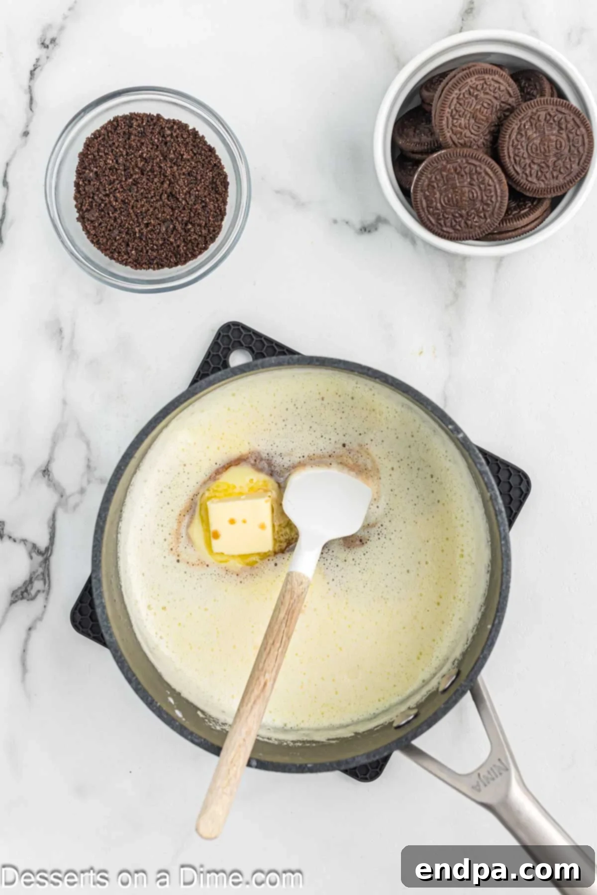 Tempered egg mixture being slowly whisked back into the saucepan.