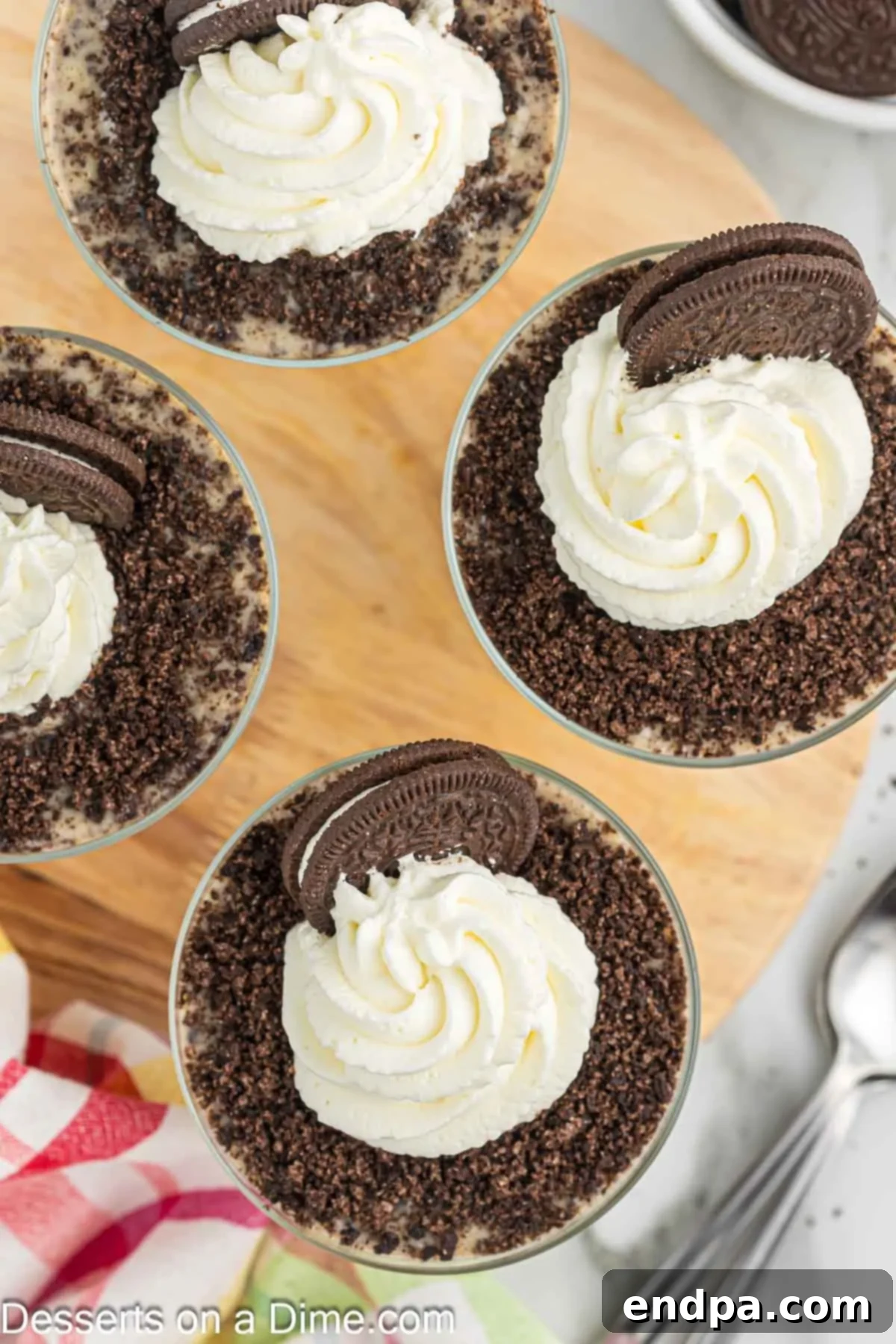 Individual serving of Oreo pudding topped with whipped cream, cookie crumbs, and a whole Oreo.